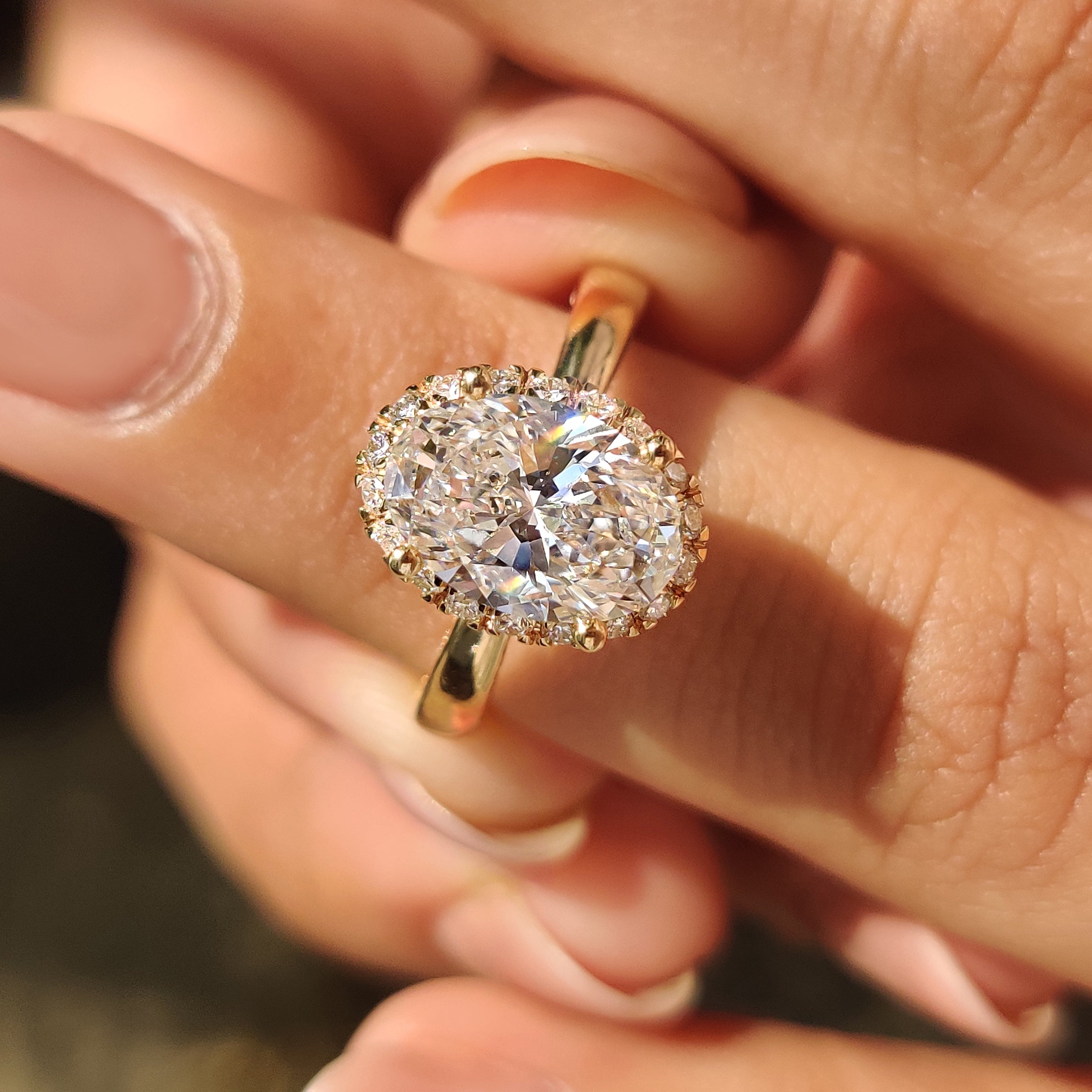 Radiant sparkle flows through pave band and oval diamond ring.
