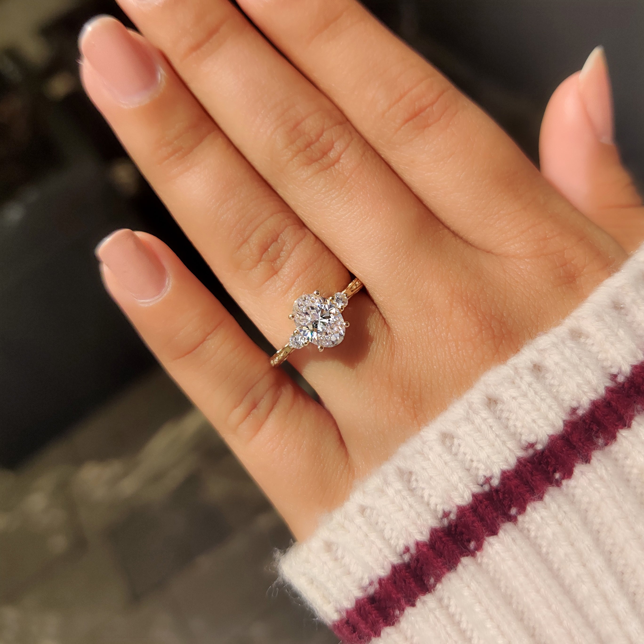 Vintage oval diamond engagement ring with detailed filigree.
