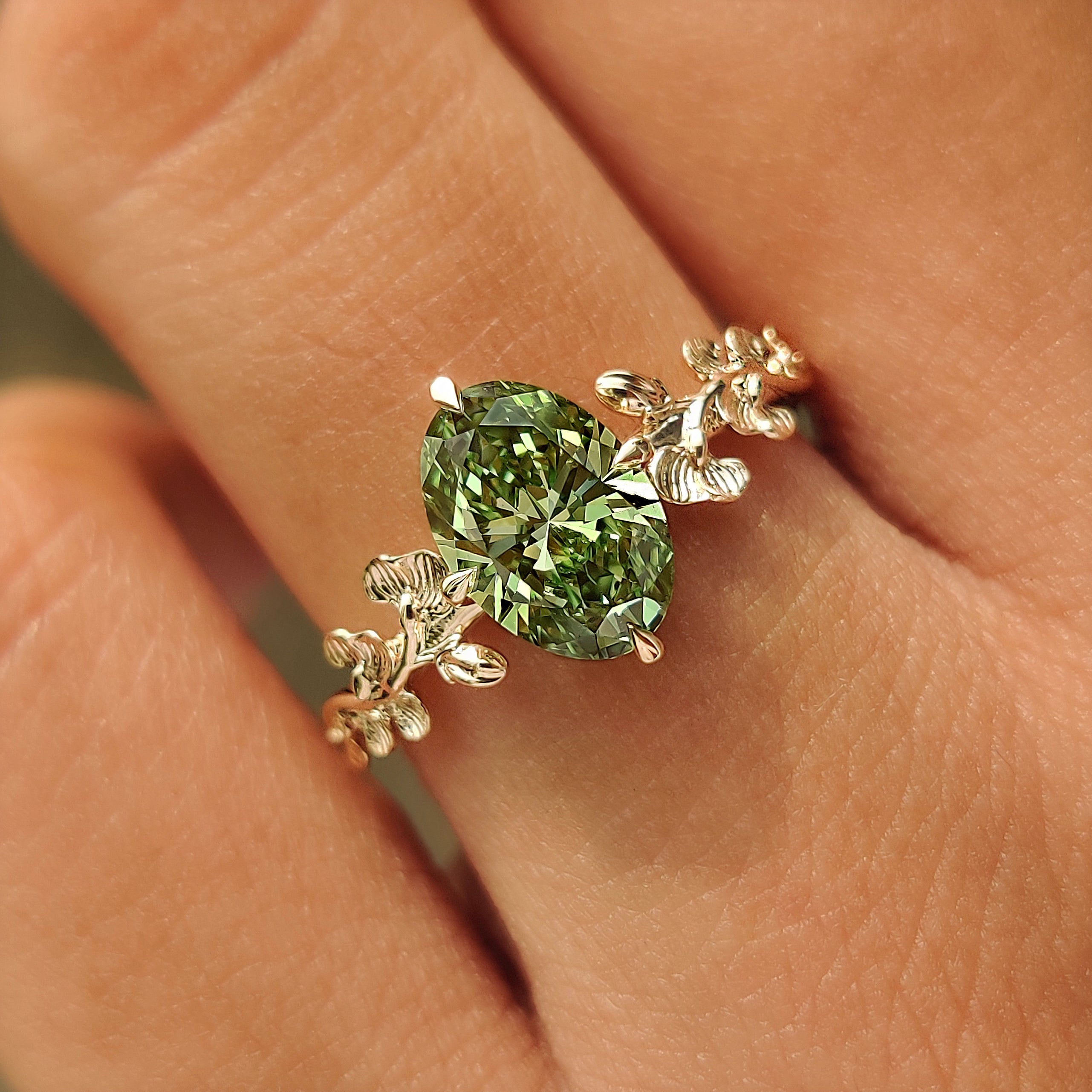 Green lab grown diamond in a nature inspired ring.
