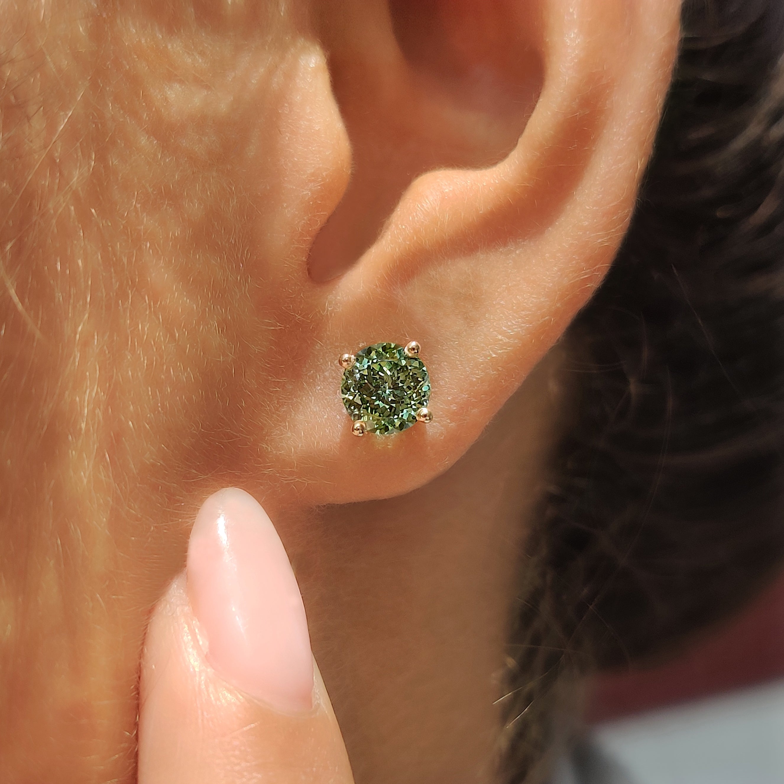 Four prong green diamond earrings with push back closure
