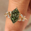 Dutch marquise engagement ring with green center diamond.
