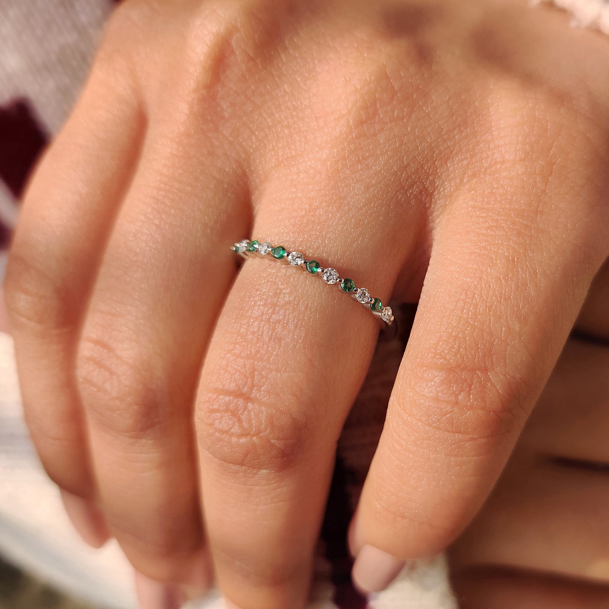 Shared prong half eternity band diamond and emerald gemstones.
