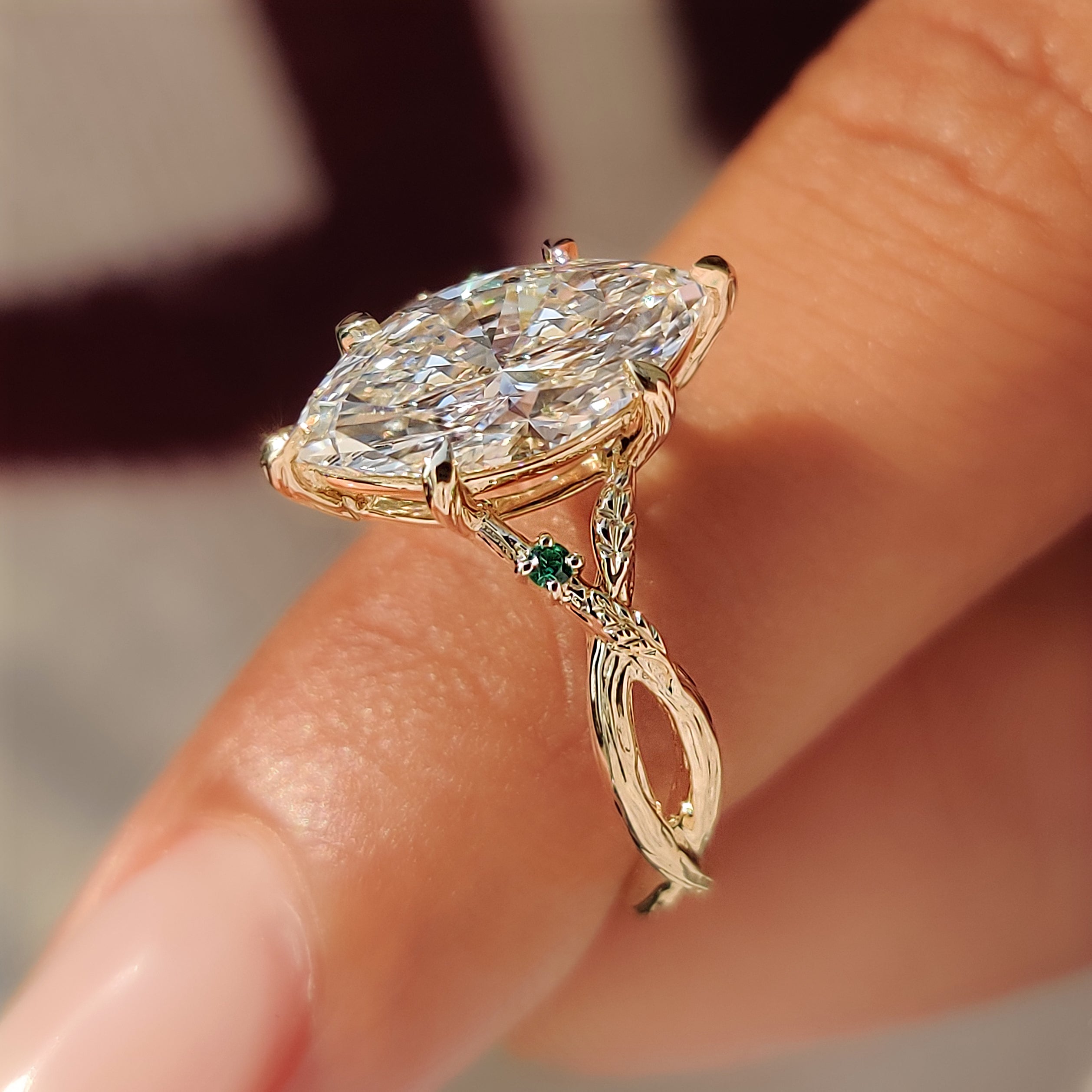 Bark textured yellow gold band on a marquise ring.
