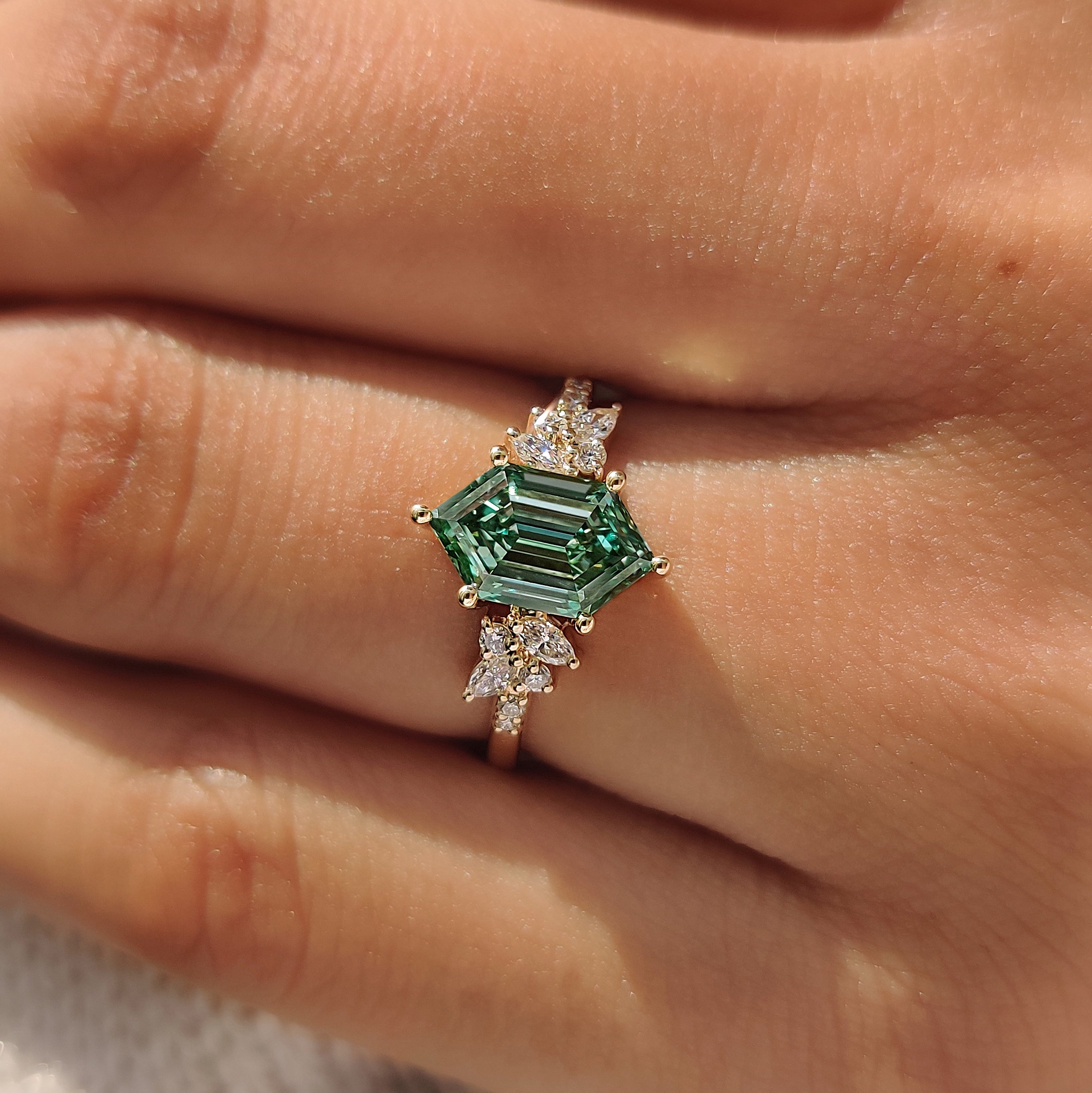 Green hexagon diamond ring in muse setting.
