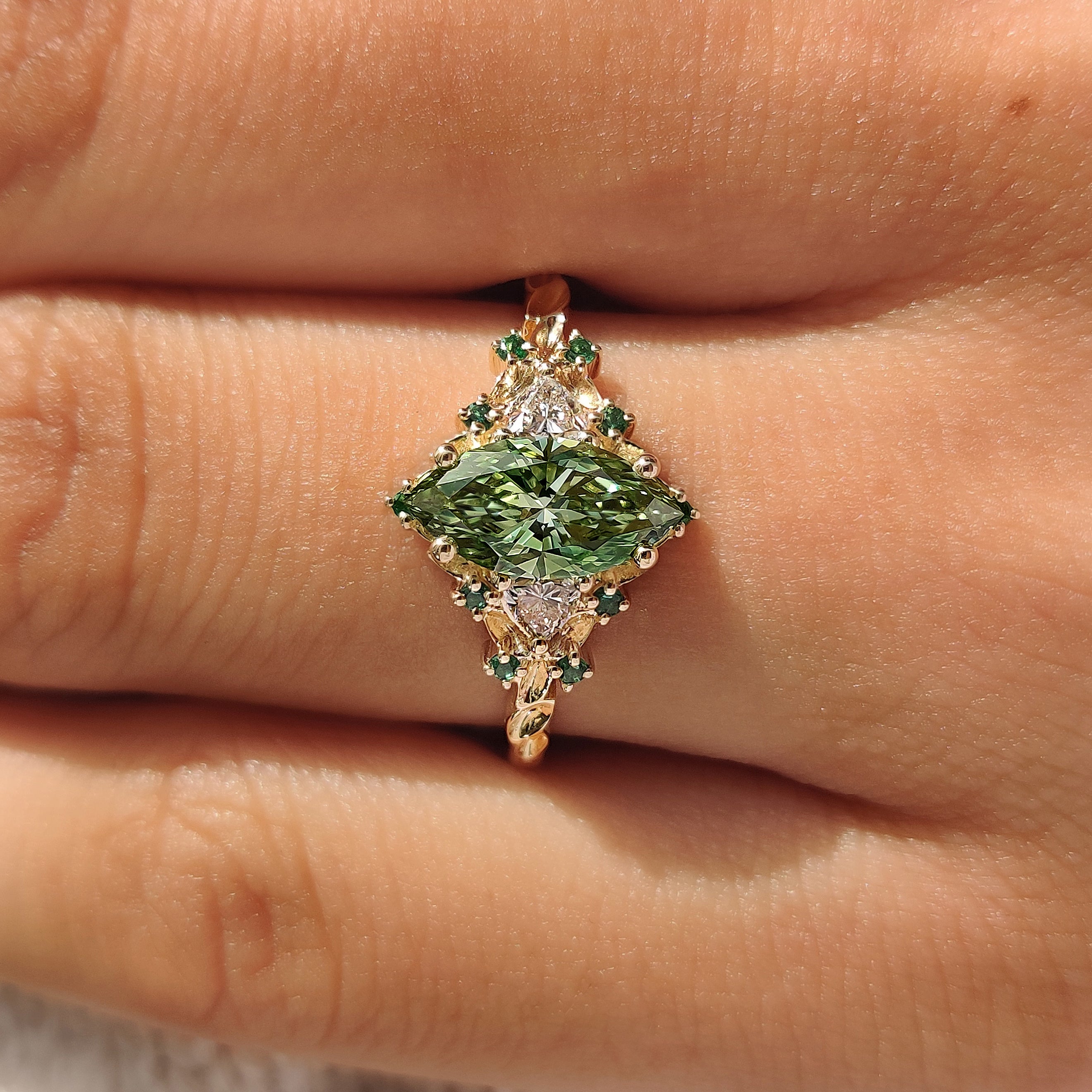 Vintage inspired cluster ring with green emerald accents.
