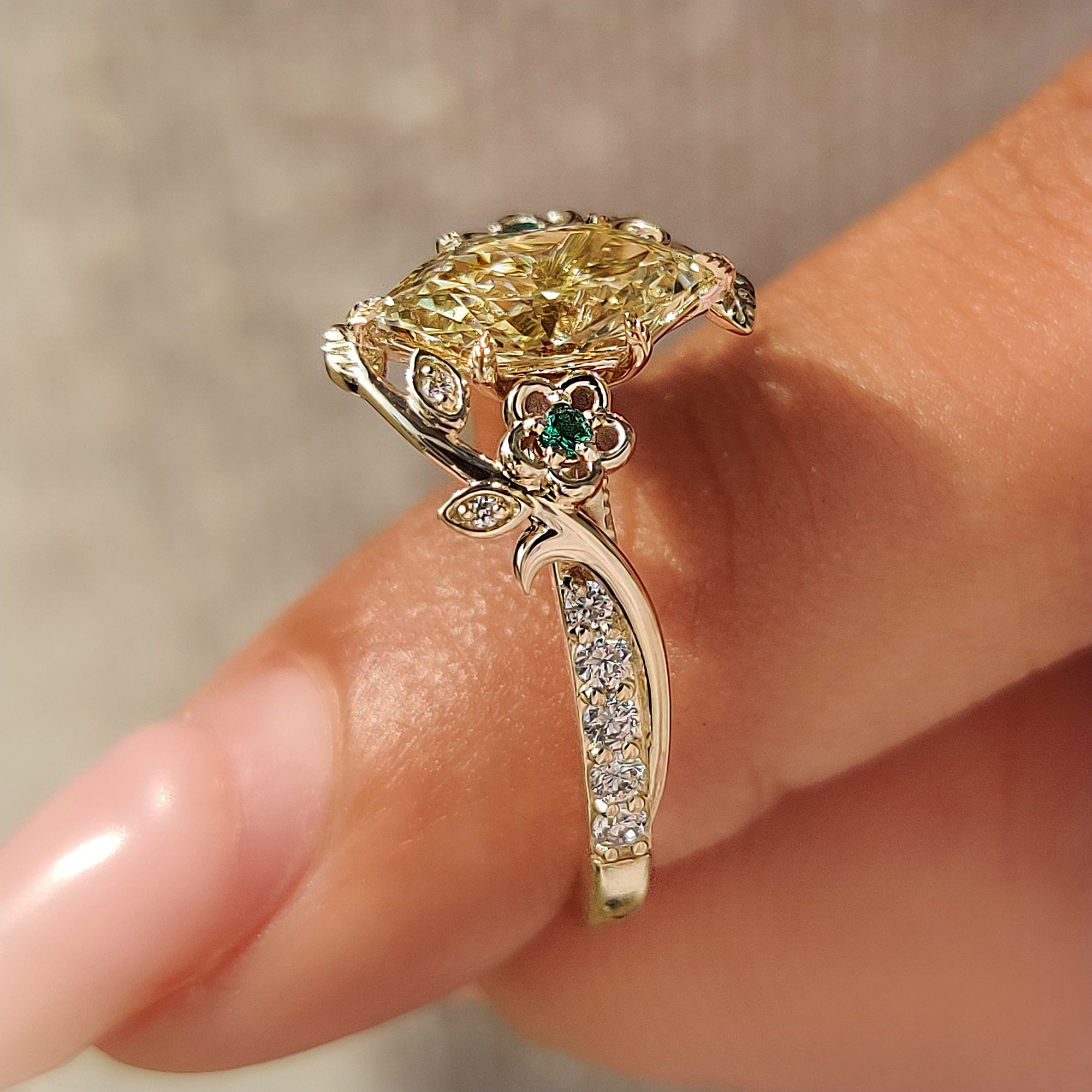 Six leaf style prongs secure the yellow Dutch marquise center diamond.
