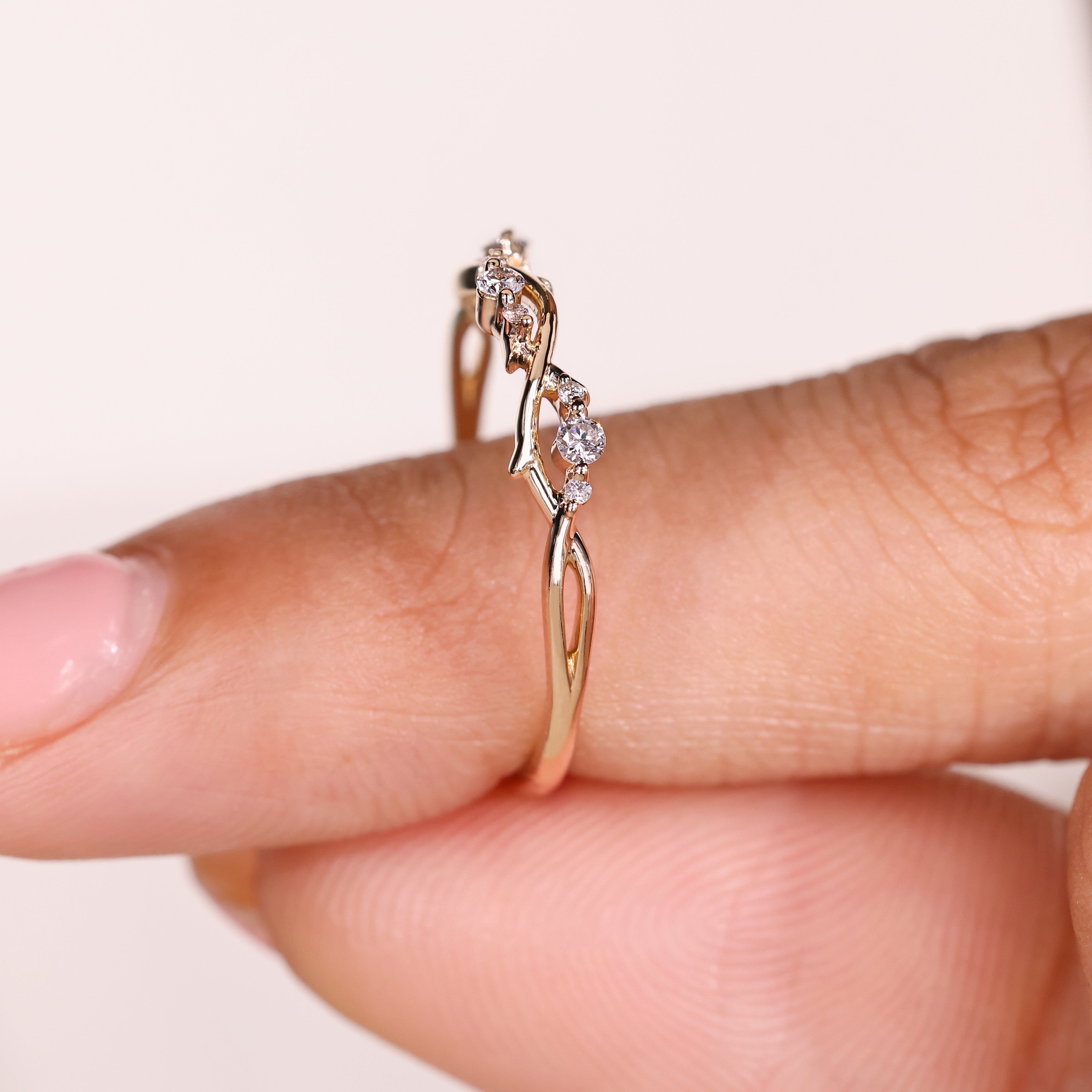 Round diamonds along curved vine shank
