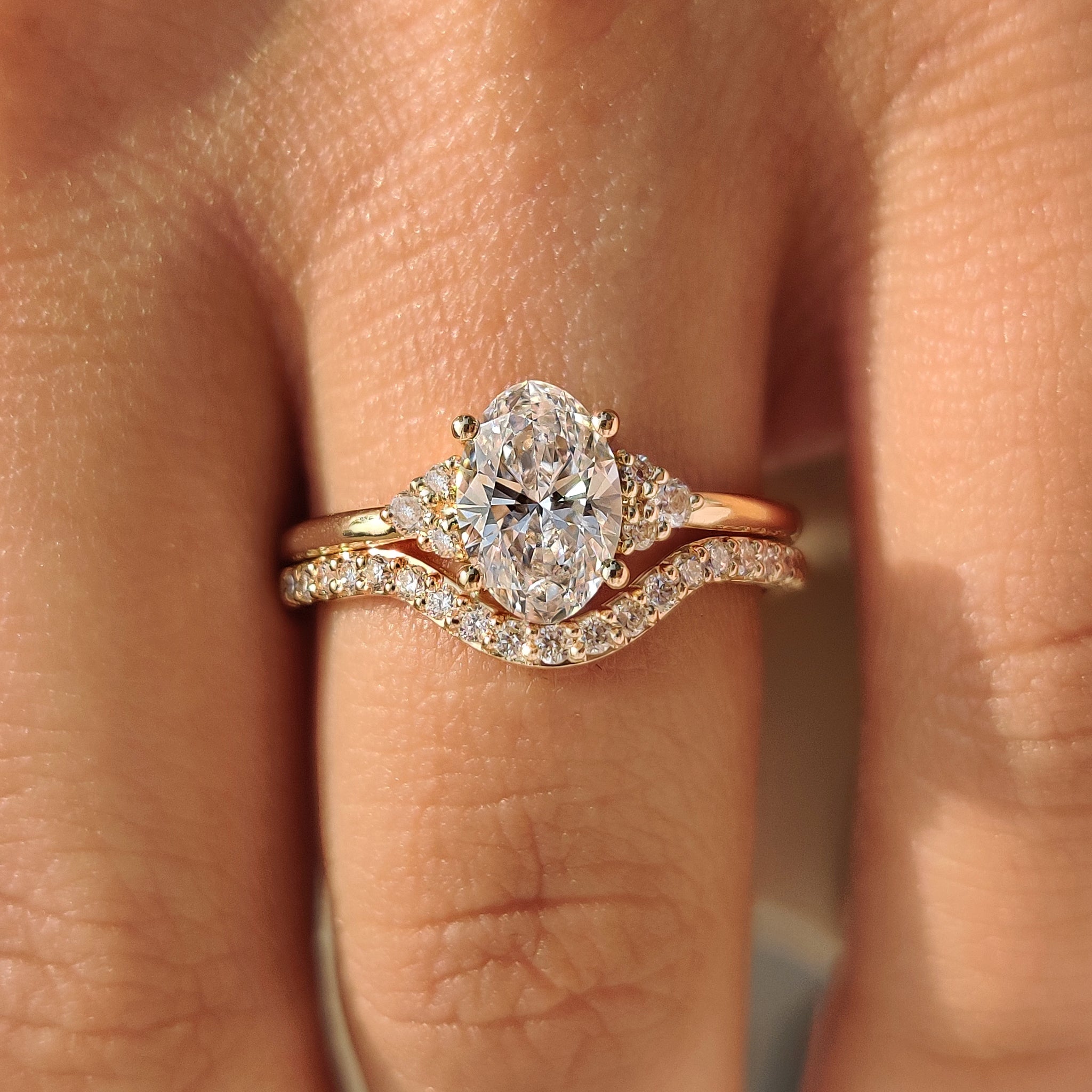Four prong oval diamond ring with eternity wedding band.

