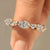 Half eternity band with round and oval diamonds.
