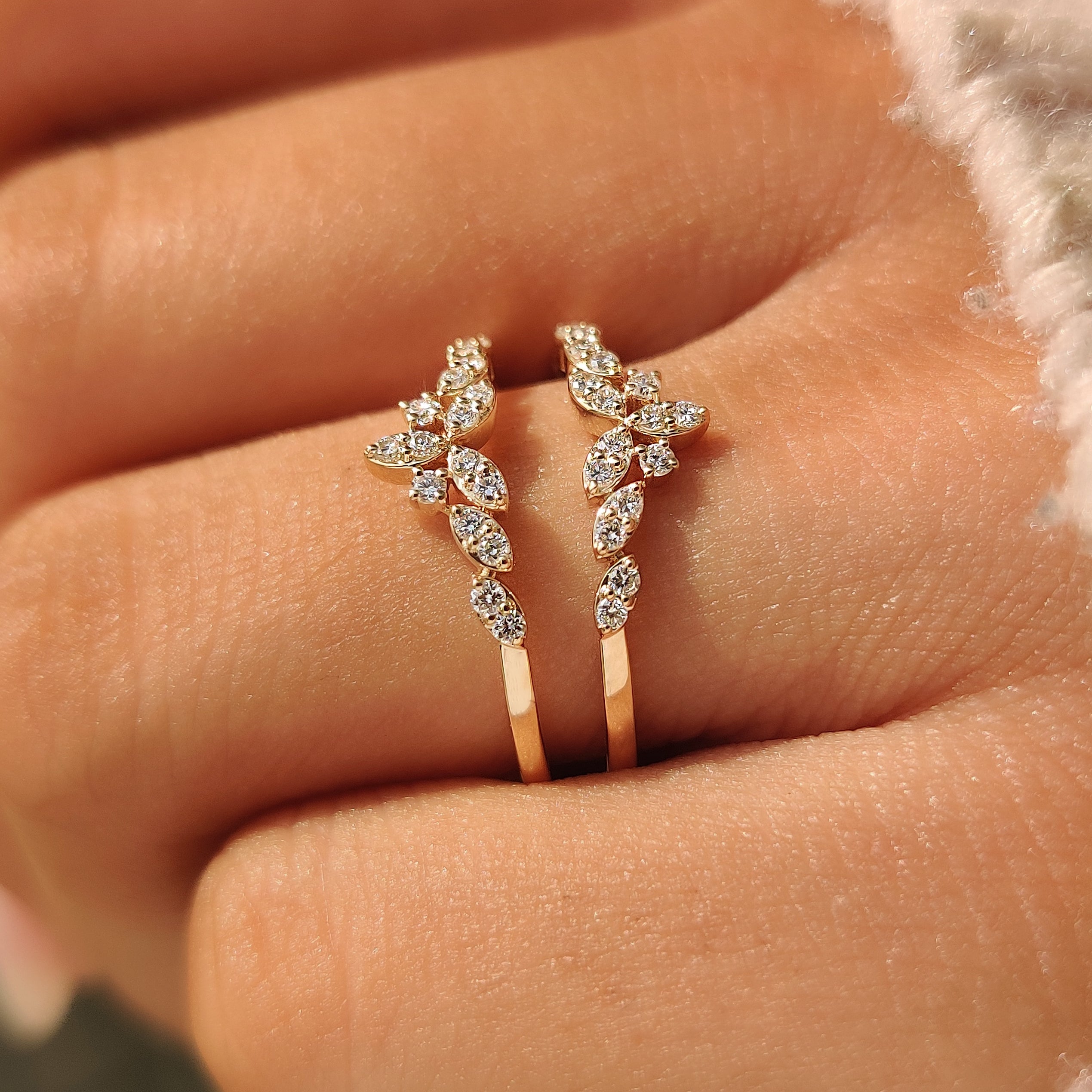 Open wrap guard wedding band designed to frame an engagement ring.
