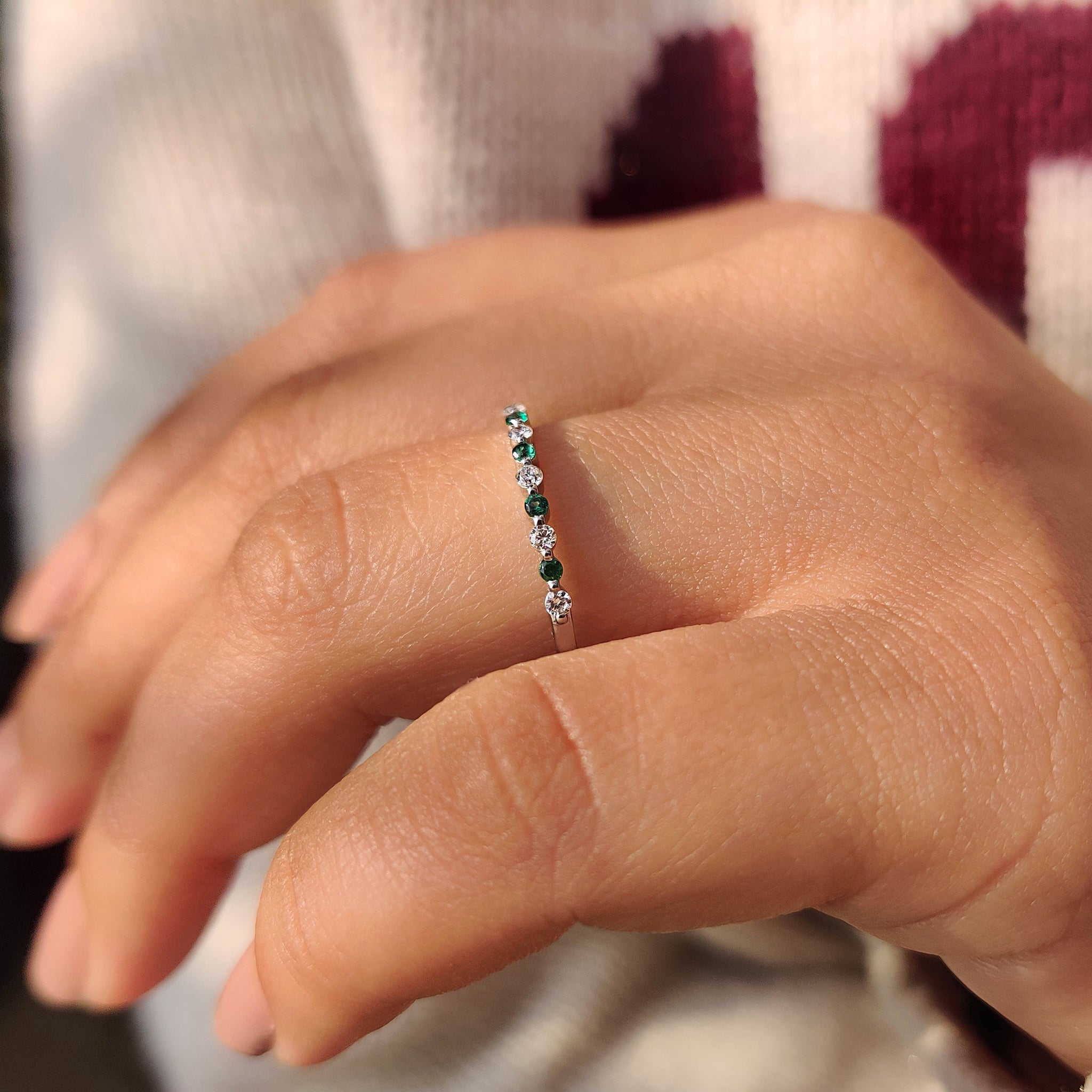 Lab grown round diamond and emerald gemstone band.
