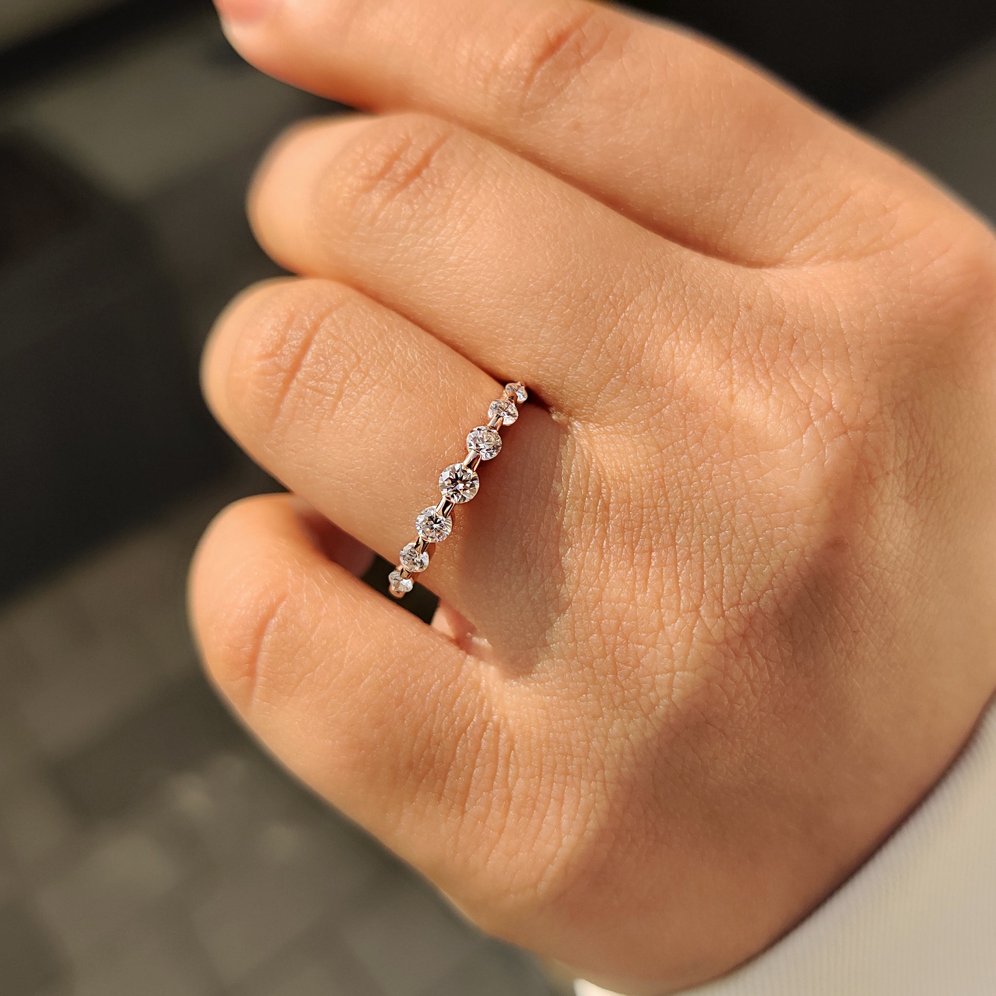 Seven stone round diamond band with shared prong setting.
