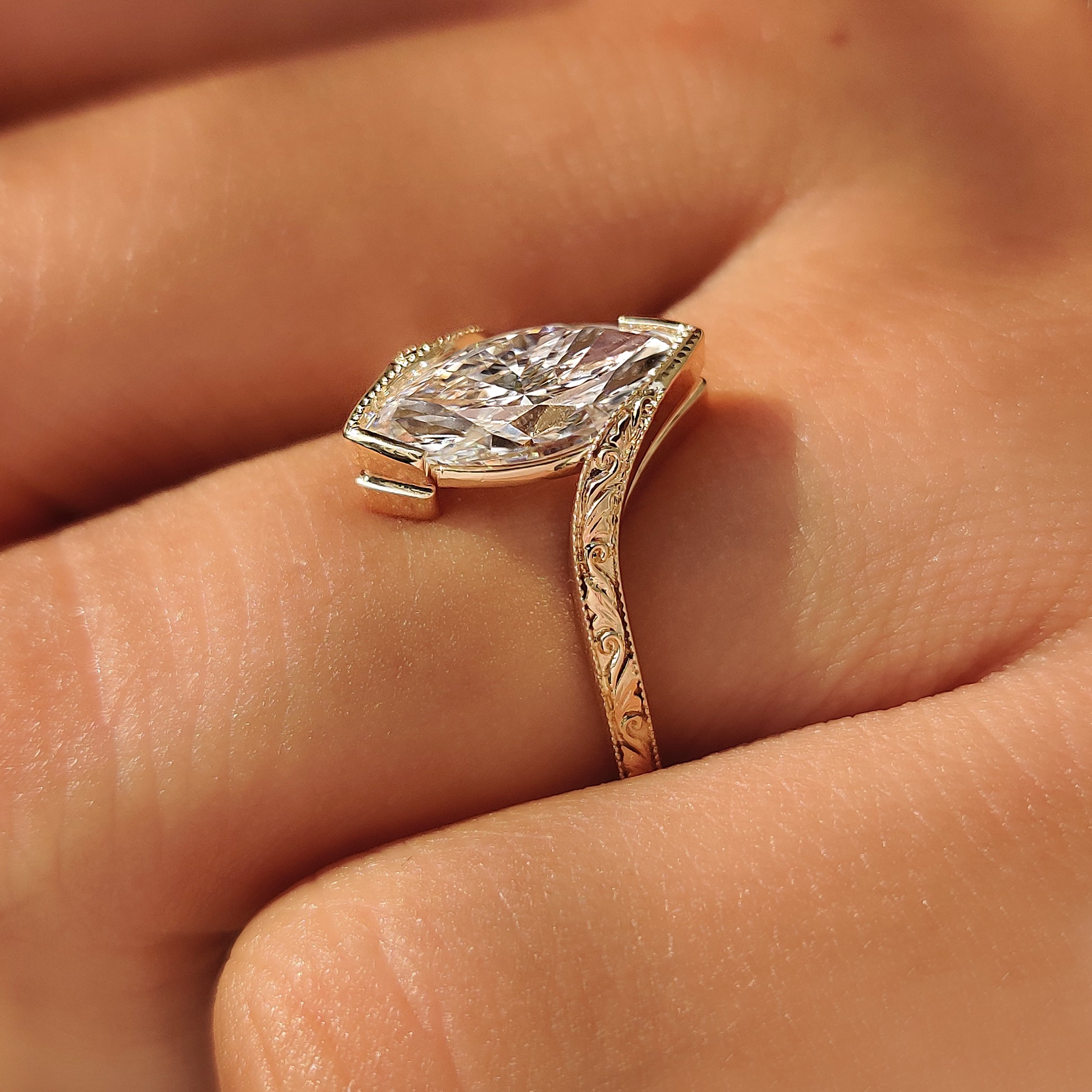 Filigree shank design on a marquise solitaire ring.

