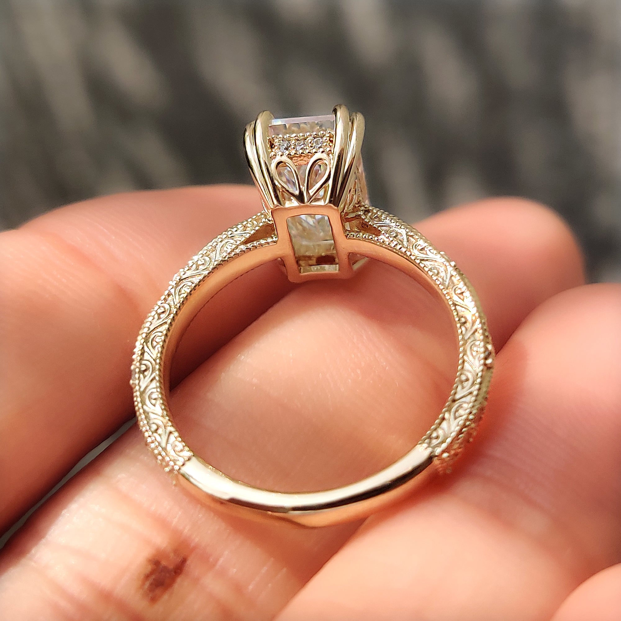Filigree emerald ring with round diamond pave.
