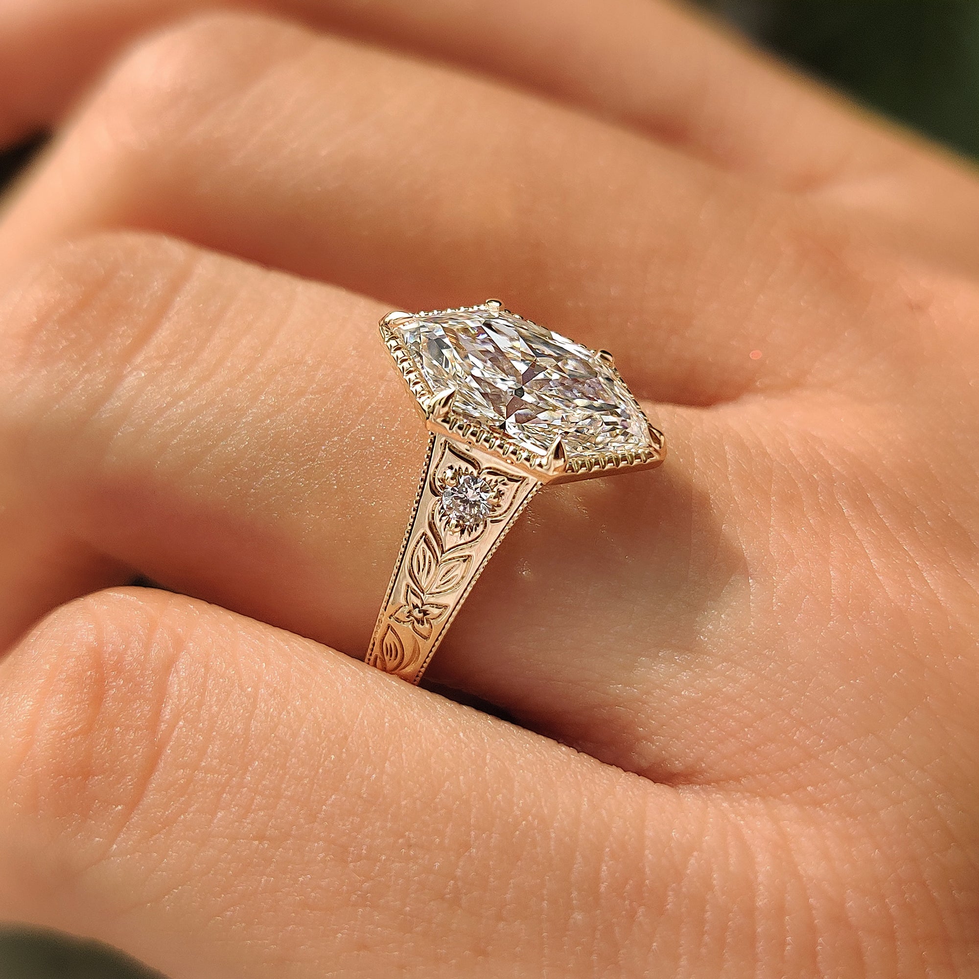 Yellow gold three stone ring with Dutch marquise cut diamond.
