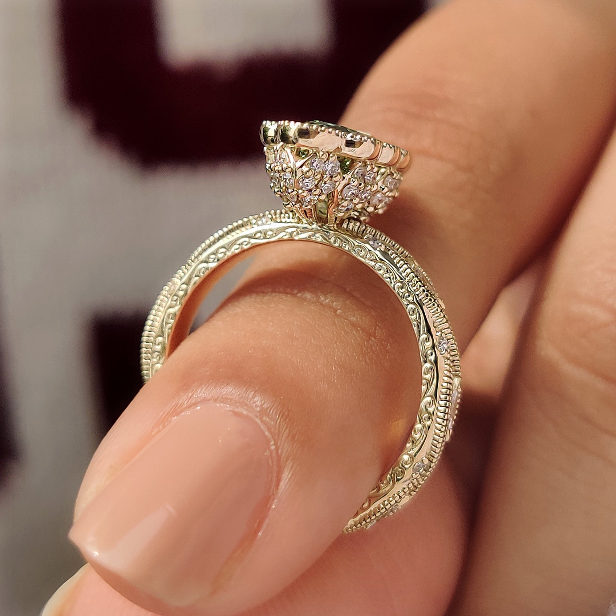 Four claw prong green marquise engagement ring.
