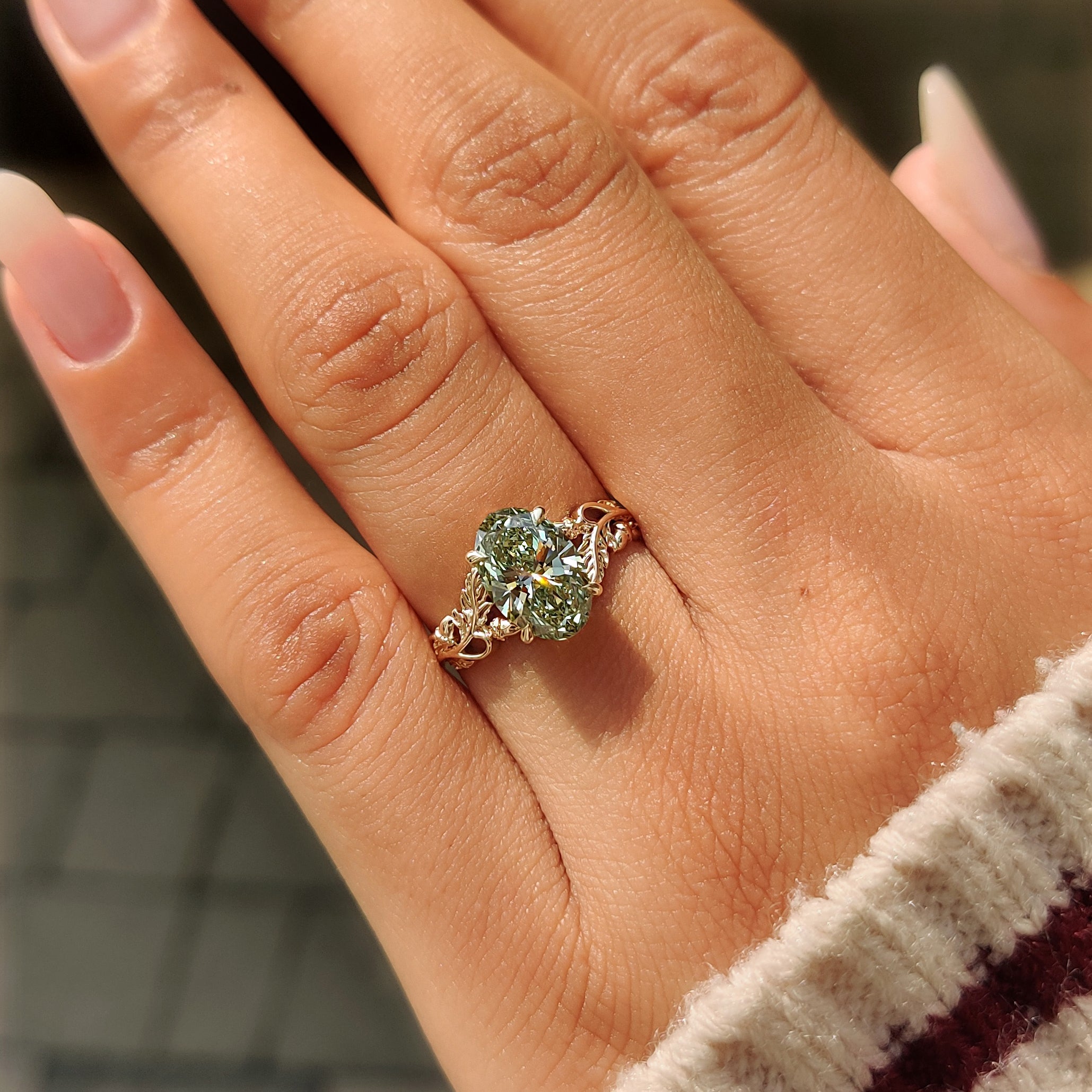 
Leaf and vine band on a green oval solitaire ring.
