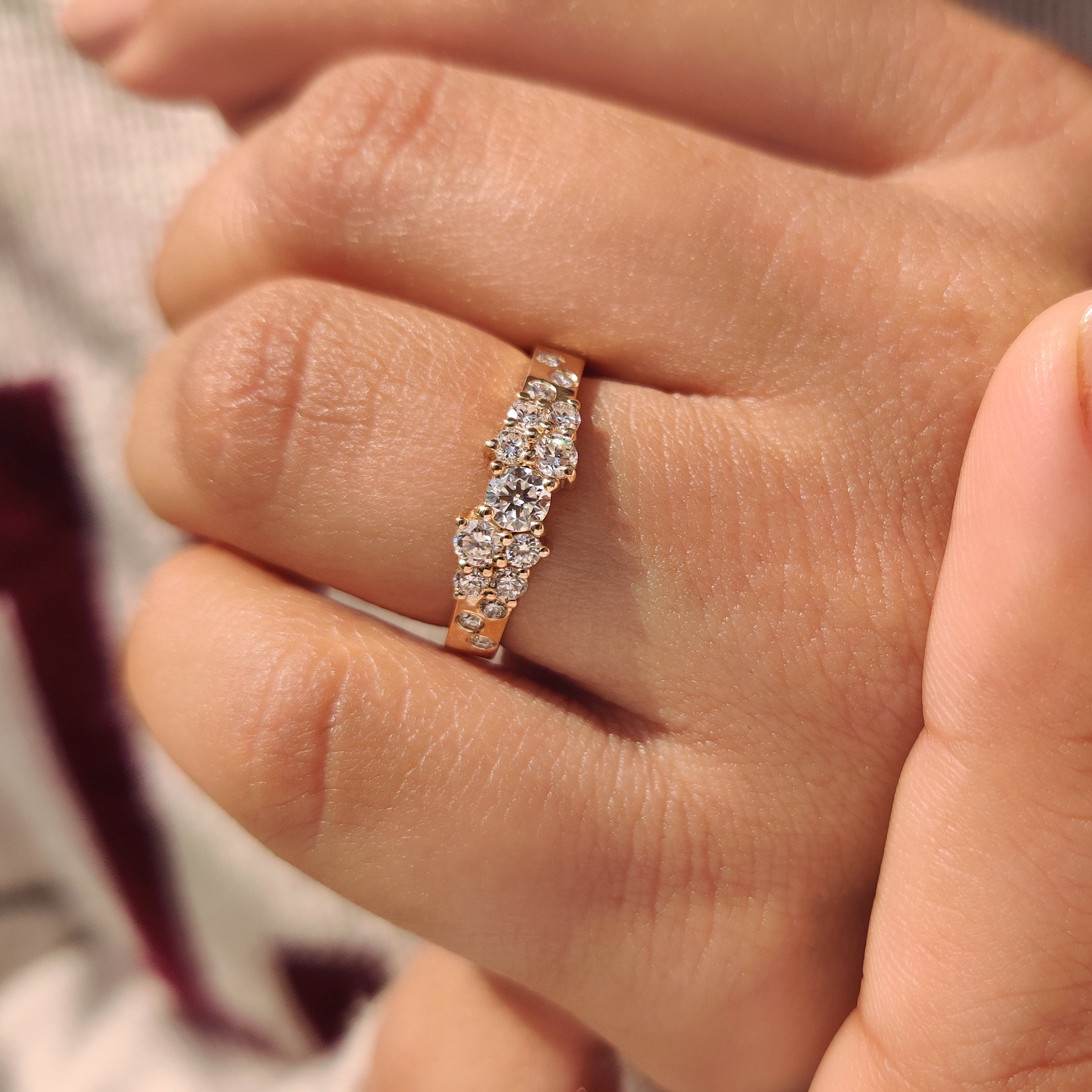 Round diamond band featuring multi diamond cluster setting.
