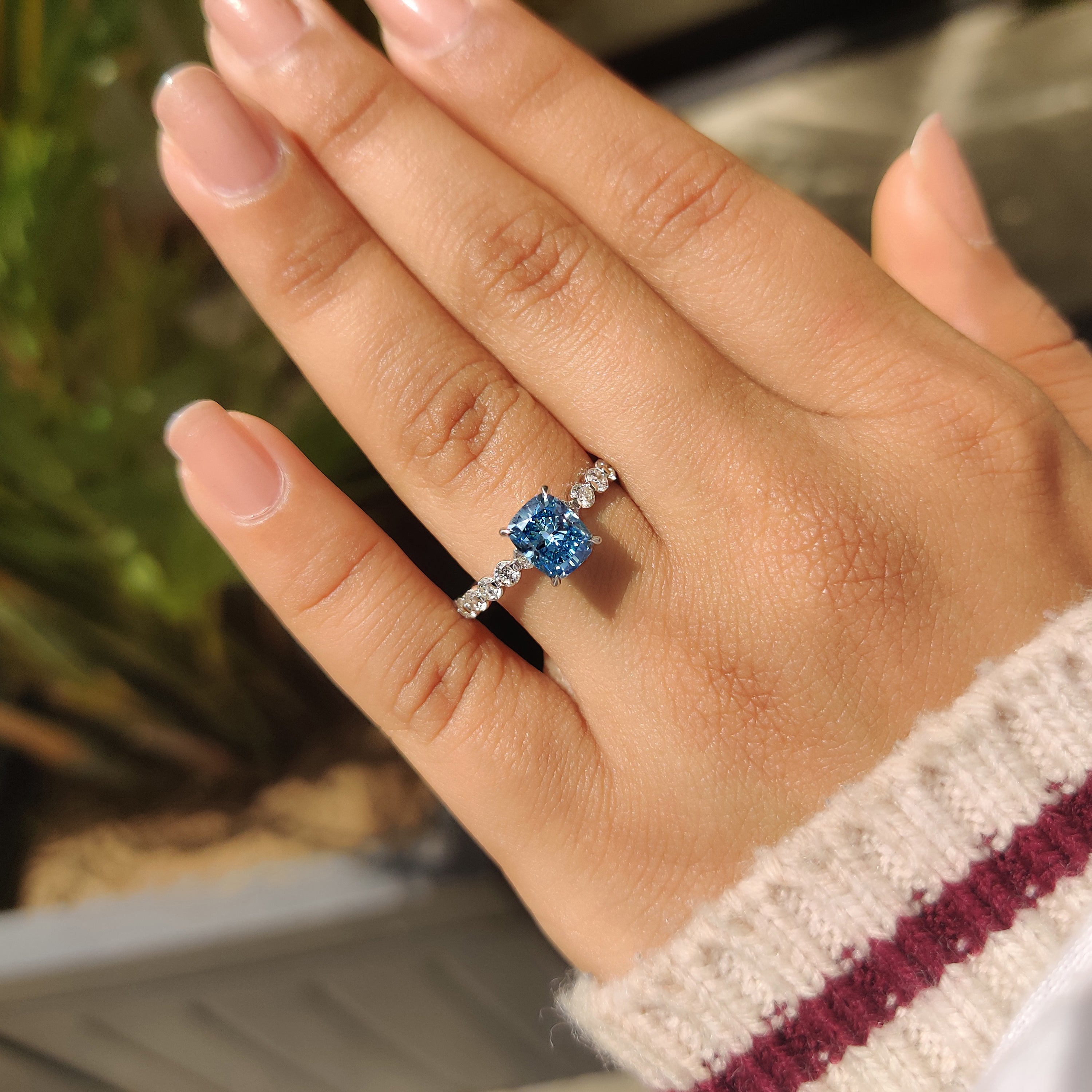 Cushion cut ring with floating bubble pave band.
