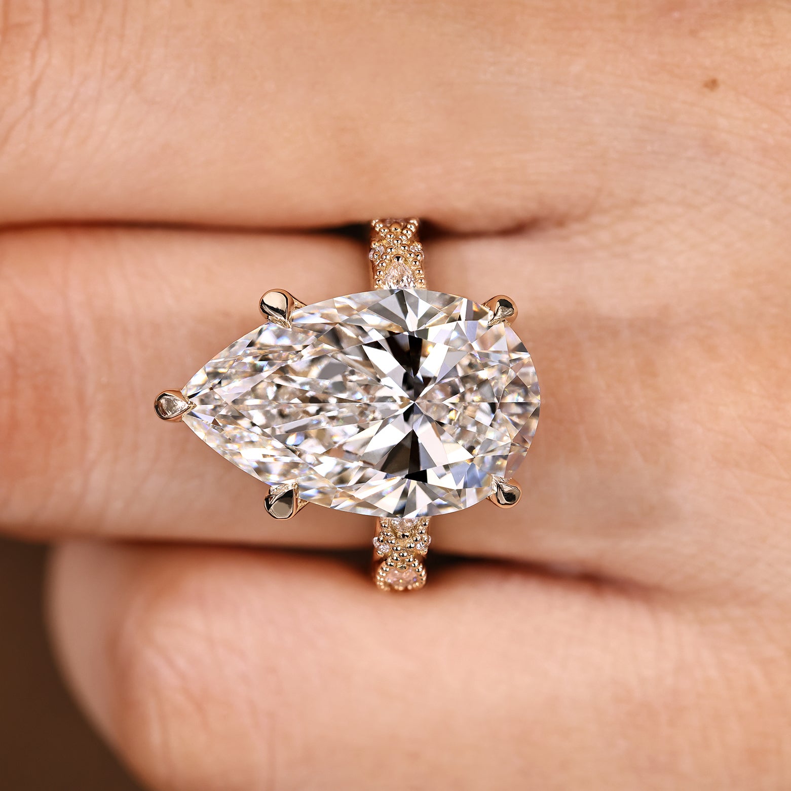 Vintage inspired pear shaped diamond ring with milgrain details
