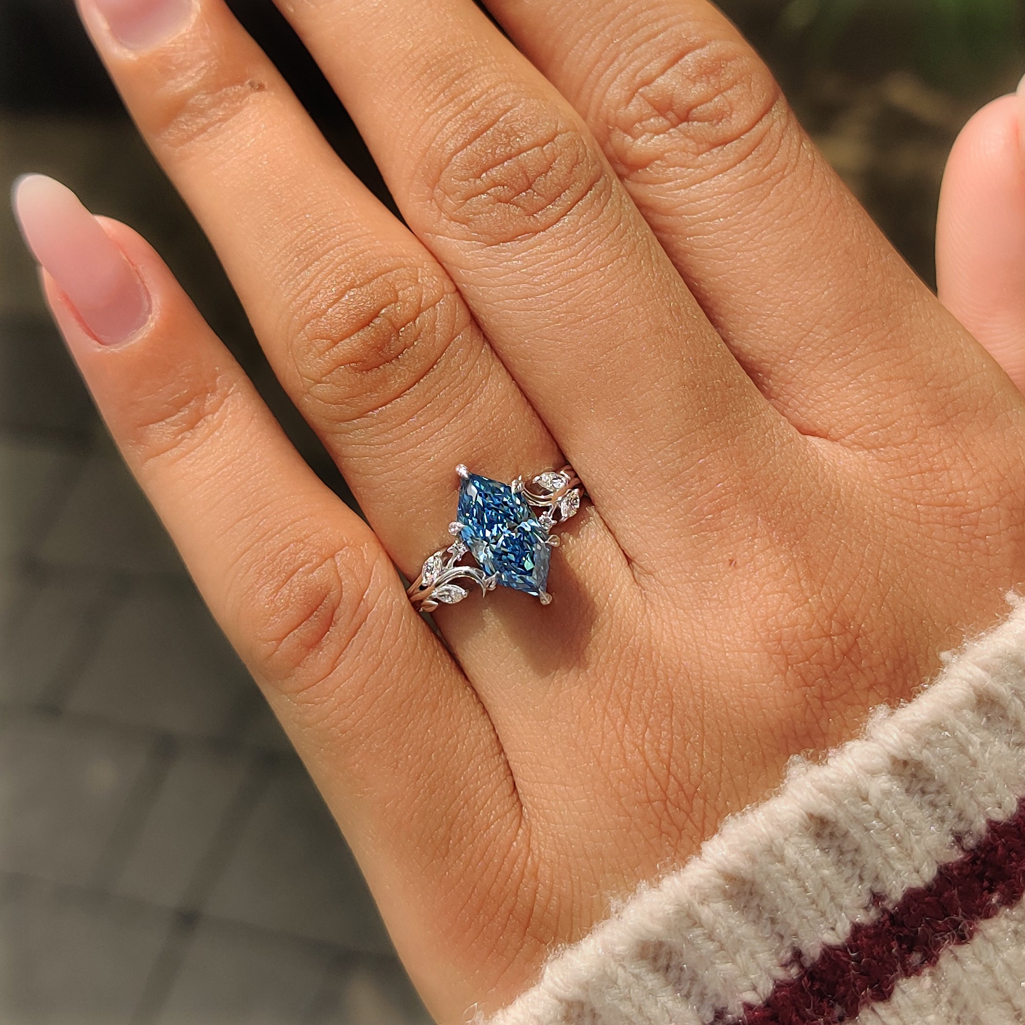 Open gallery basket setting below blue Dutch marquise diamond.
