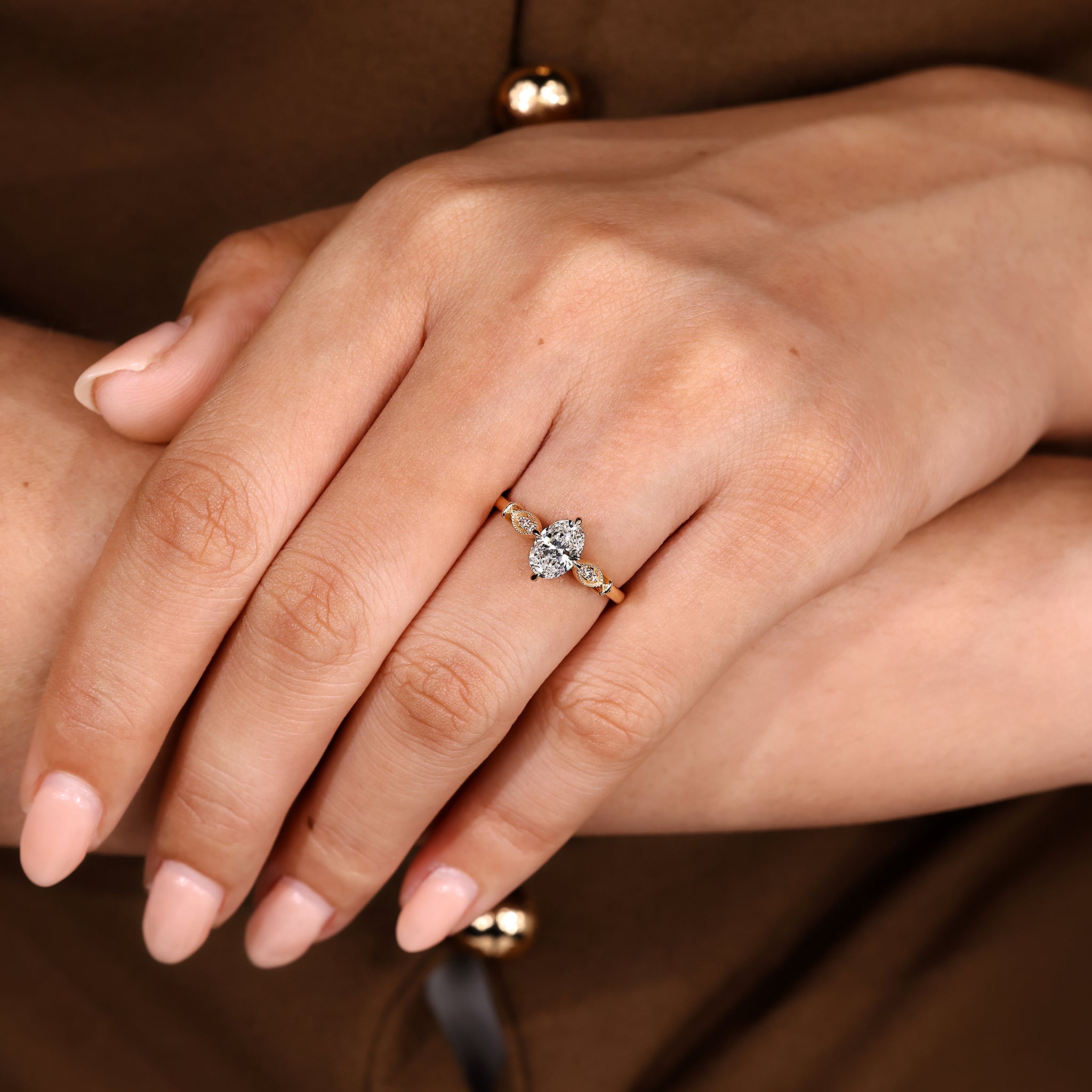 Compass claw prong oval diamond ring with side stones
