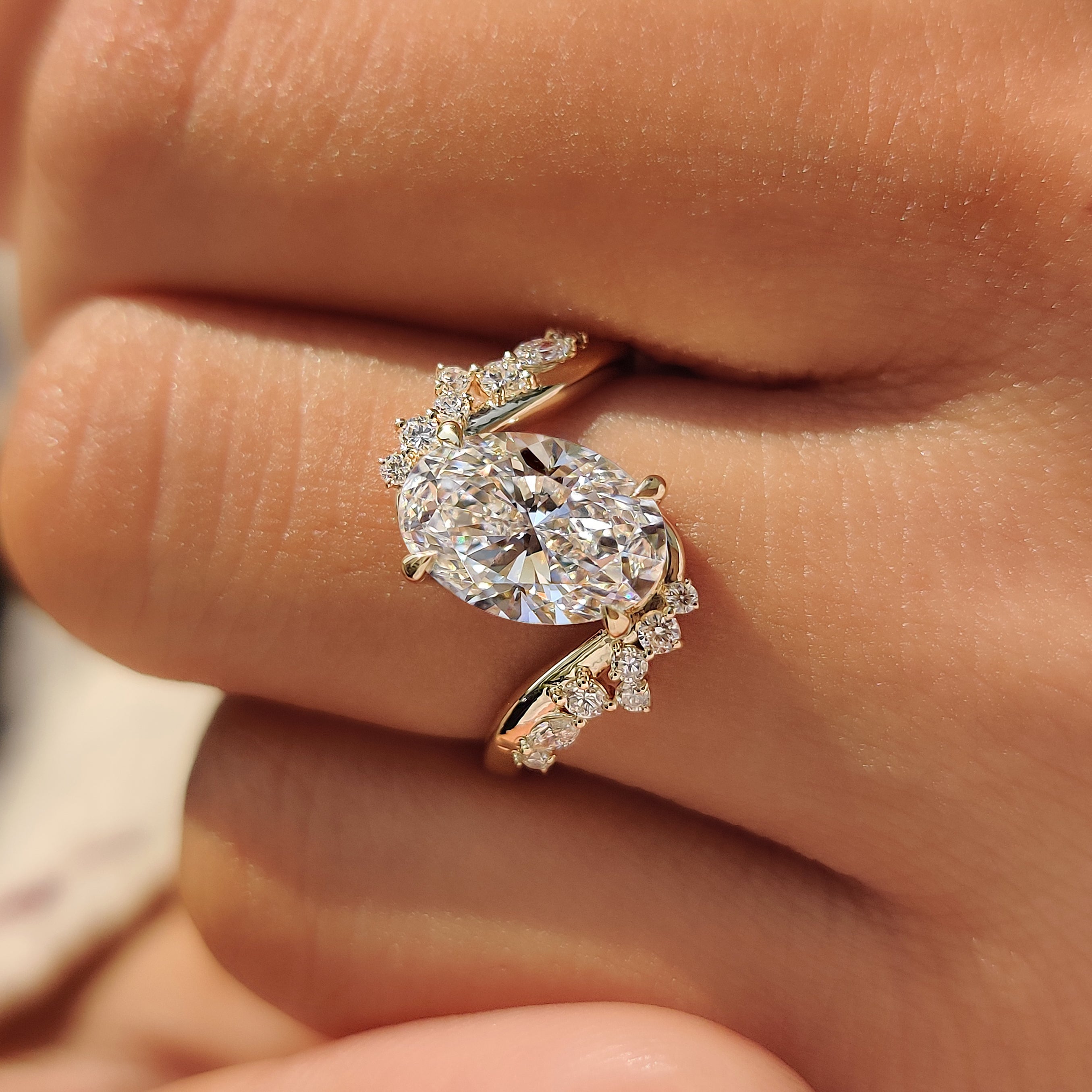 Bypass setting with an oval center diamond and side stones.
