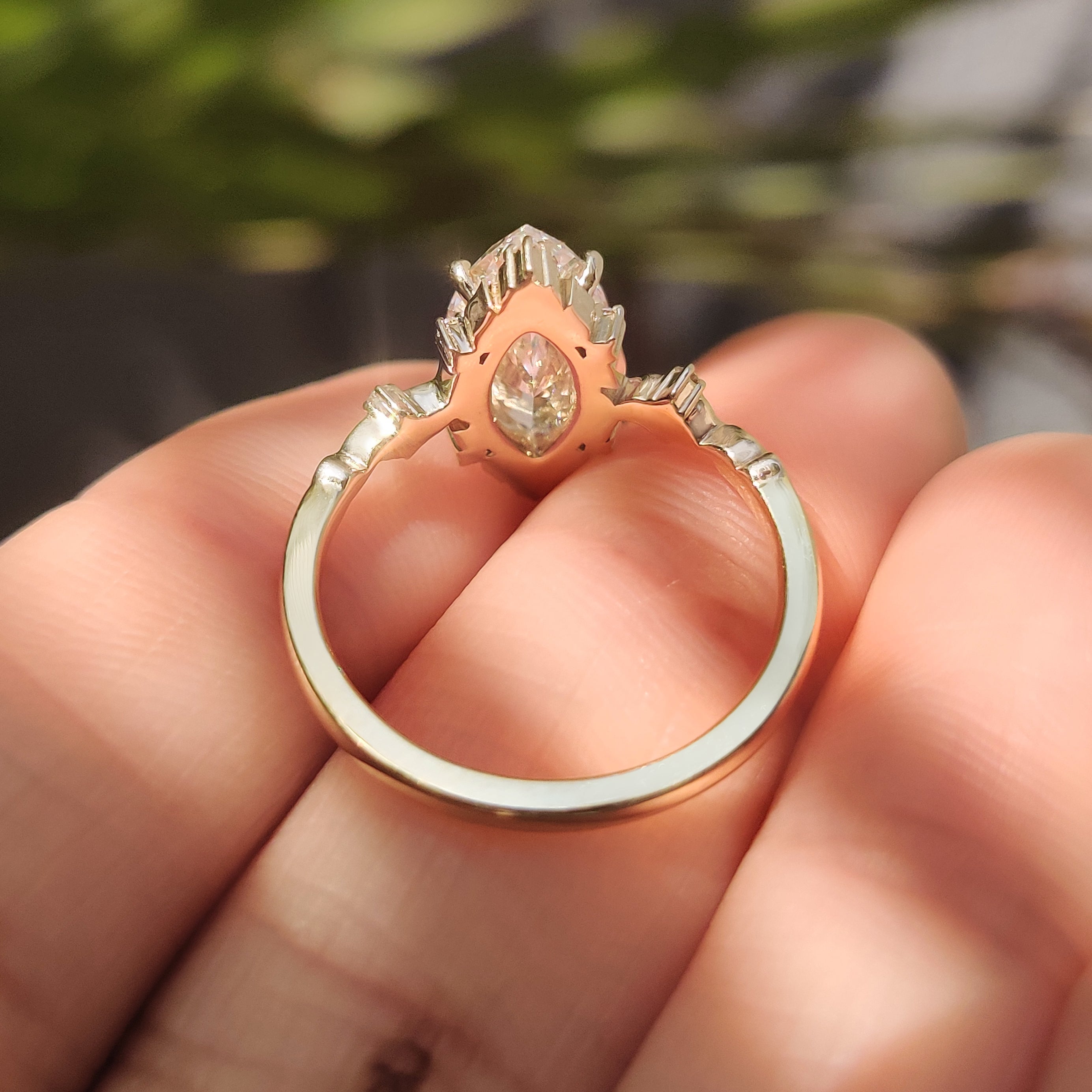 Marquise lab diamond ring with round side stones cluster.

