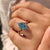 Blue aquamarine diamond ring with twisted shank and halo
