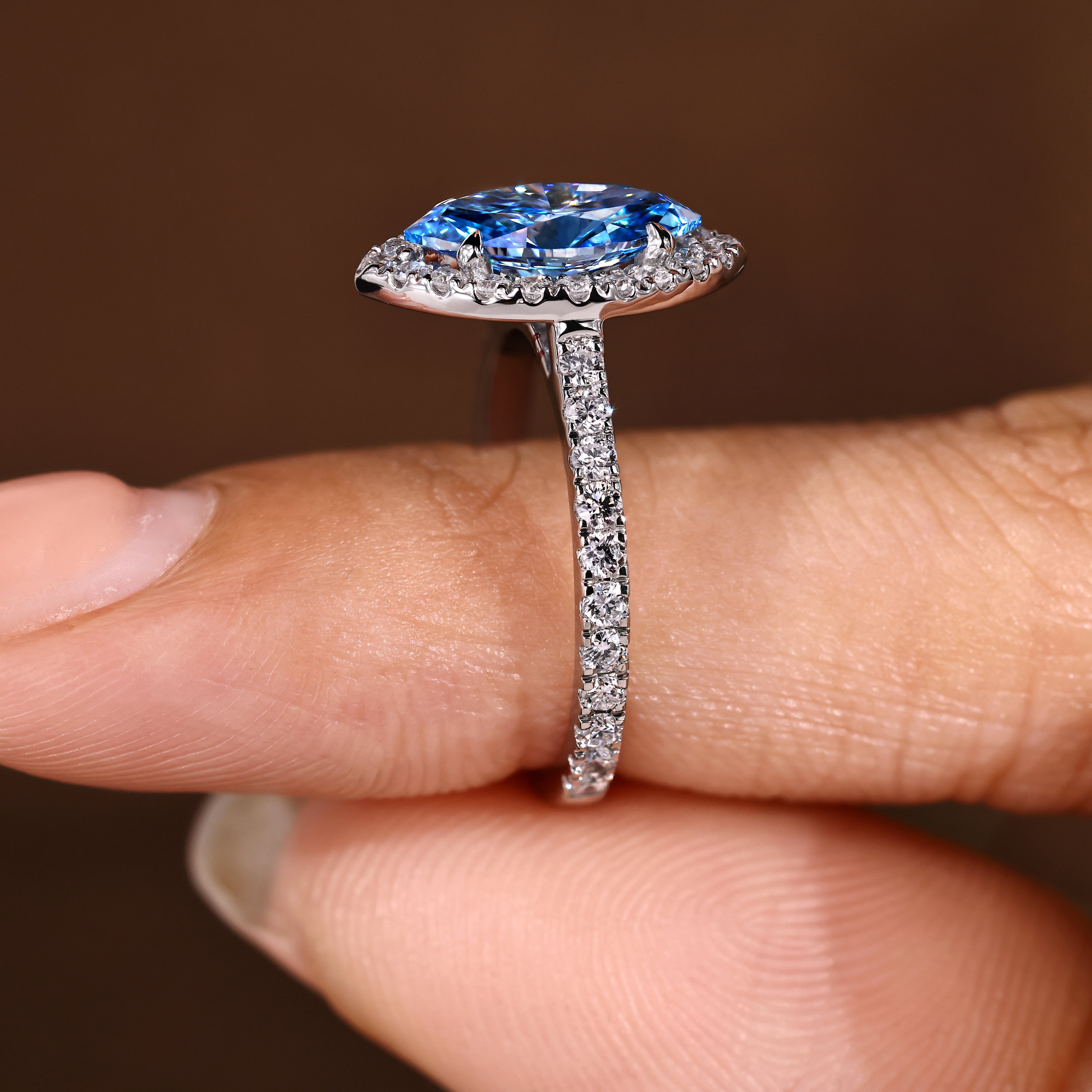 Marquise diamond ring with round halo and pave details
