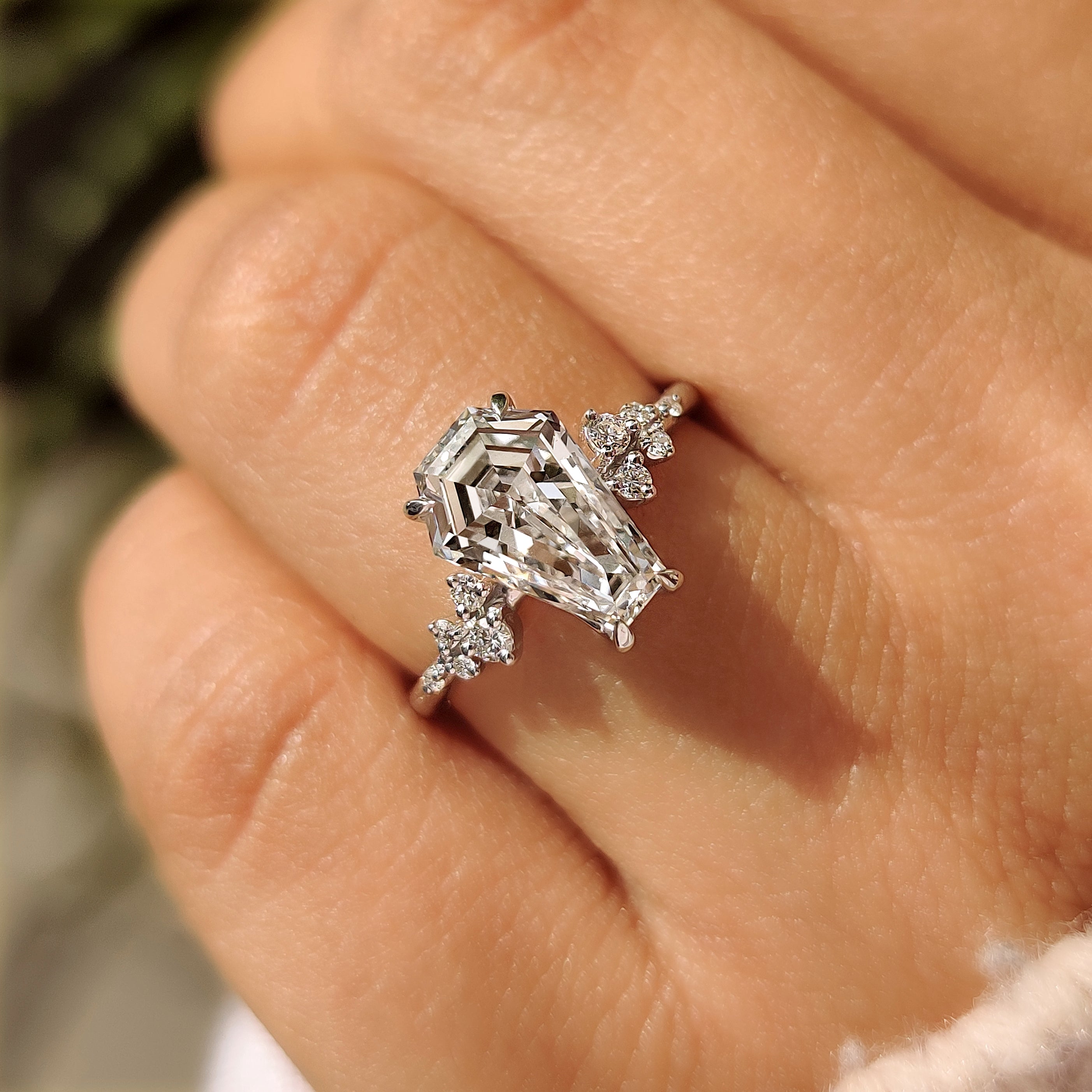 Coffin cut diamond ring with muse setting and side stones
