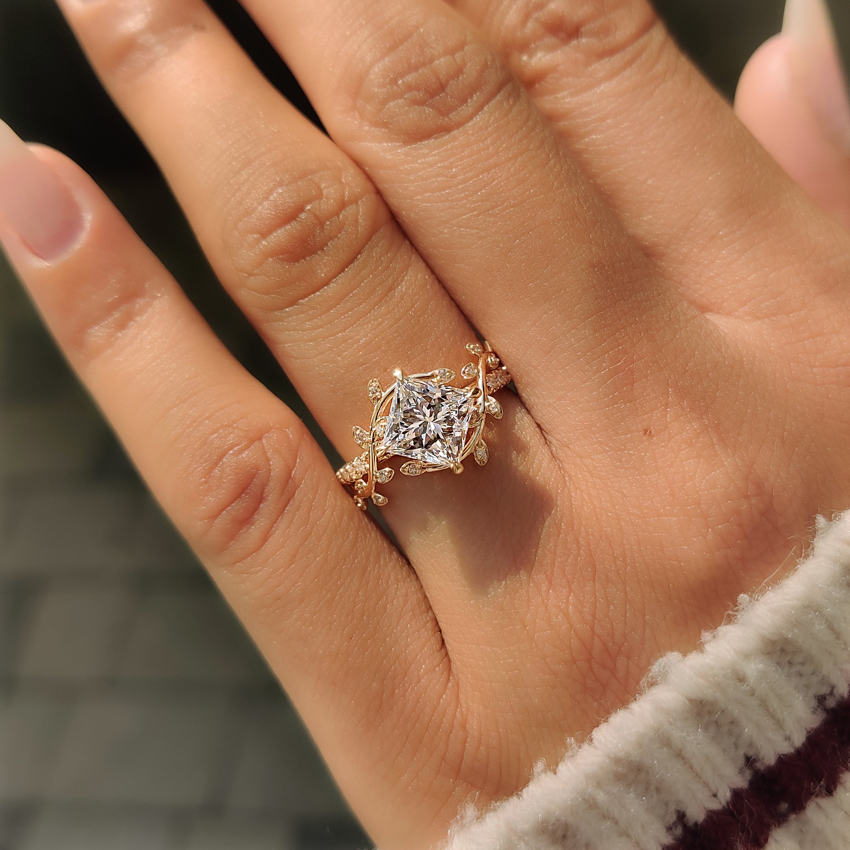 Nature inspired engagement ring with leaf and vine detailing.
