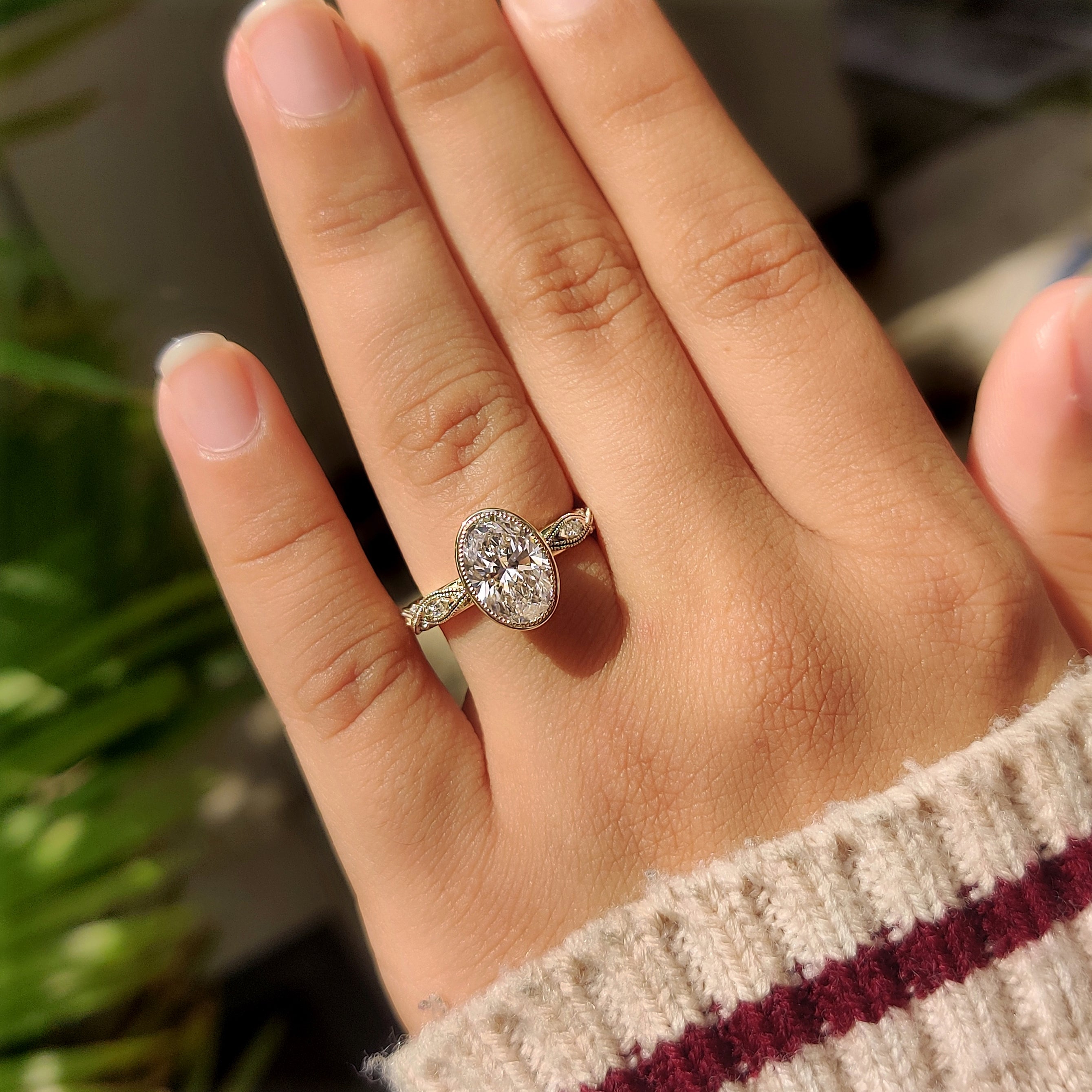 Oval center diamond bezel engagement ring
