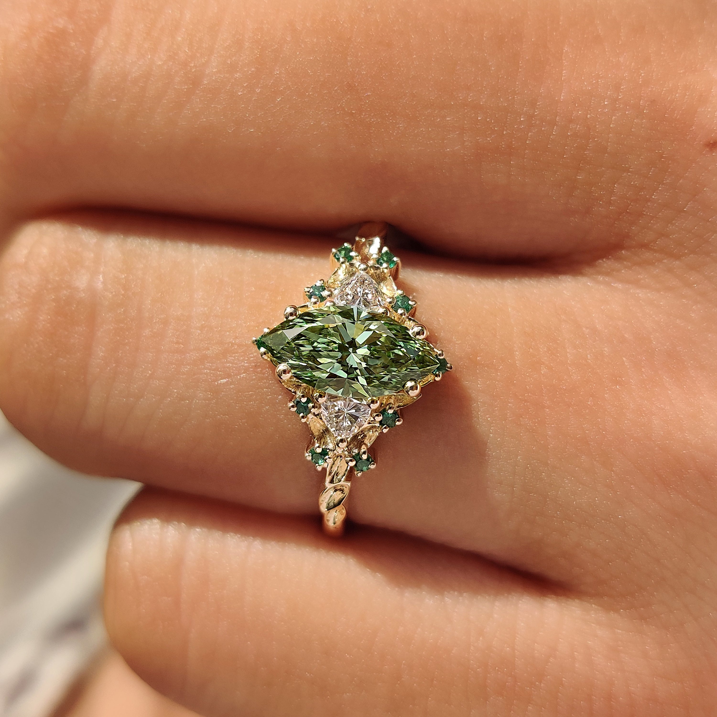 Nature inspired cluster ring with green diamonds.
