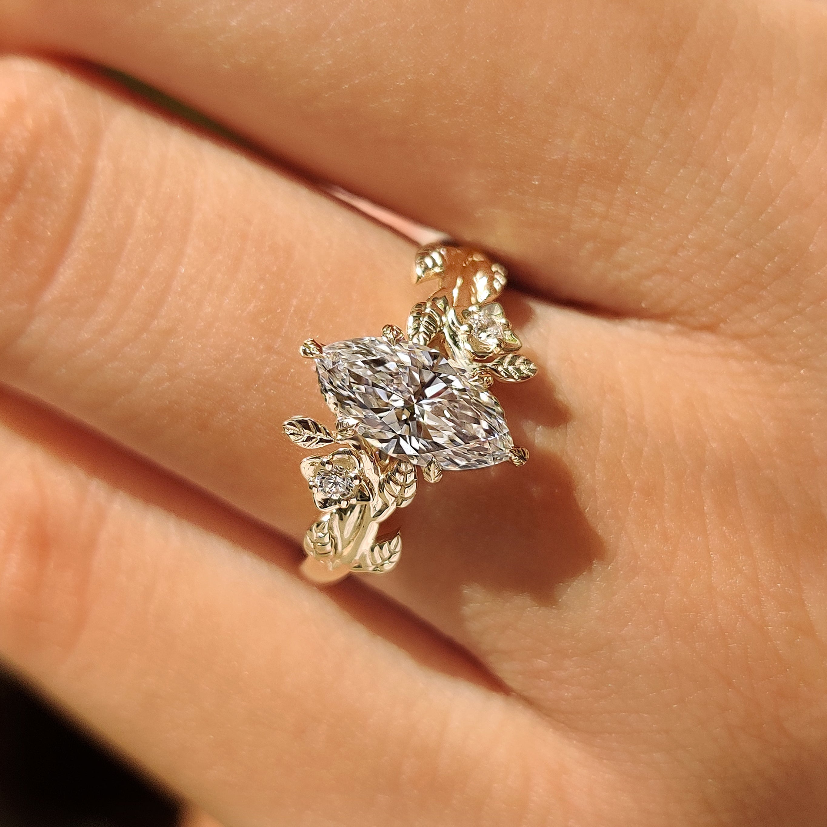 Marquise engagement ring with cluster setting and round stones

