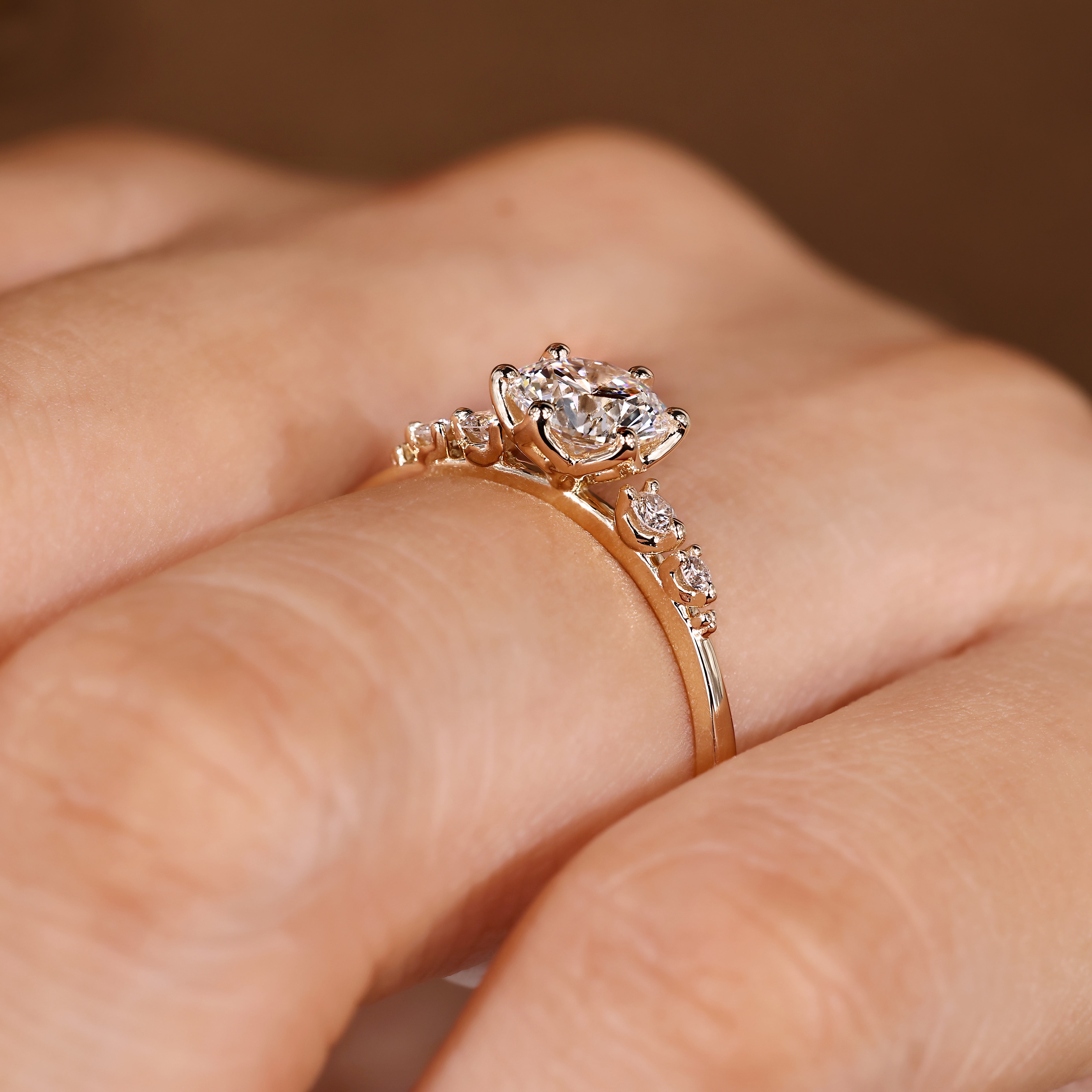 Round diamond ring with tulip setting and side stones
