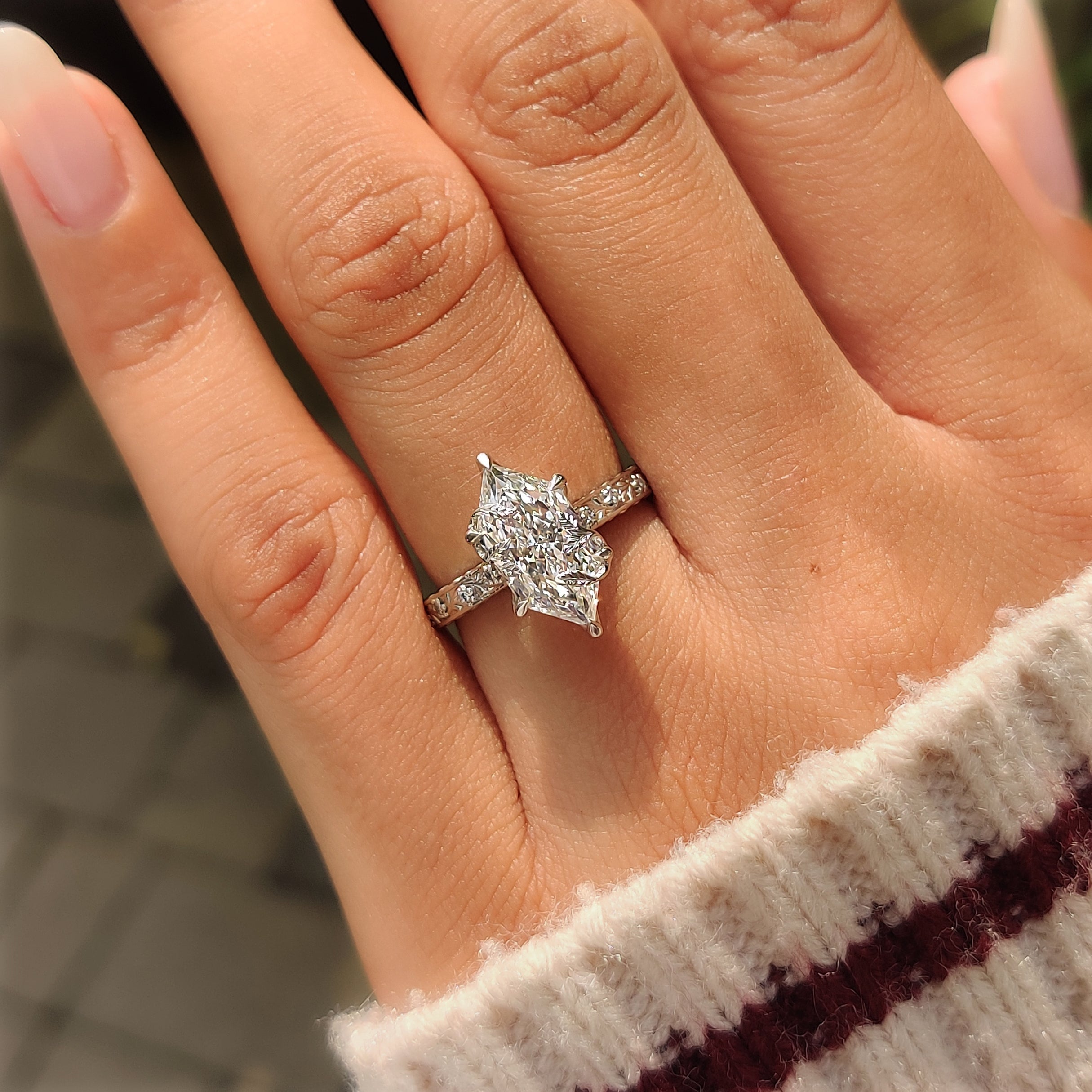 Hand engraved floral details along the ring shank.
