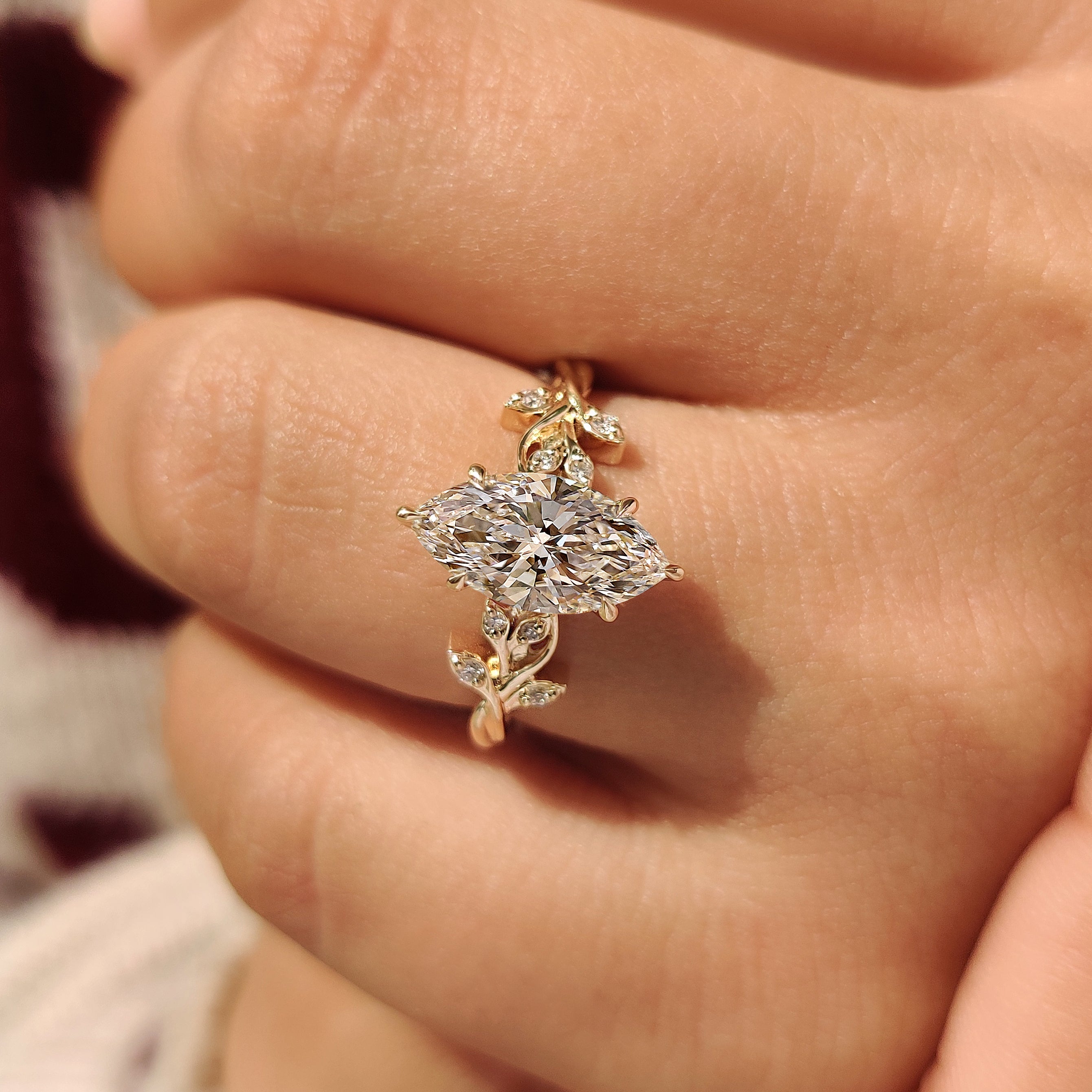 Six claw prong marquise ring with leaf detail.
