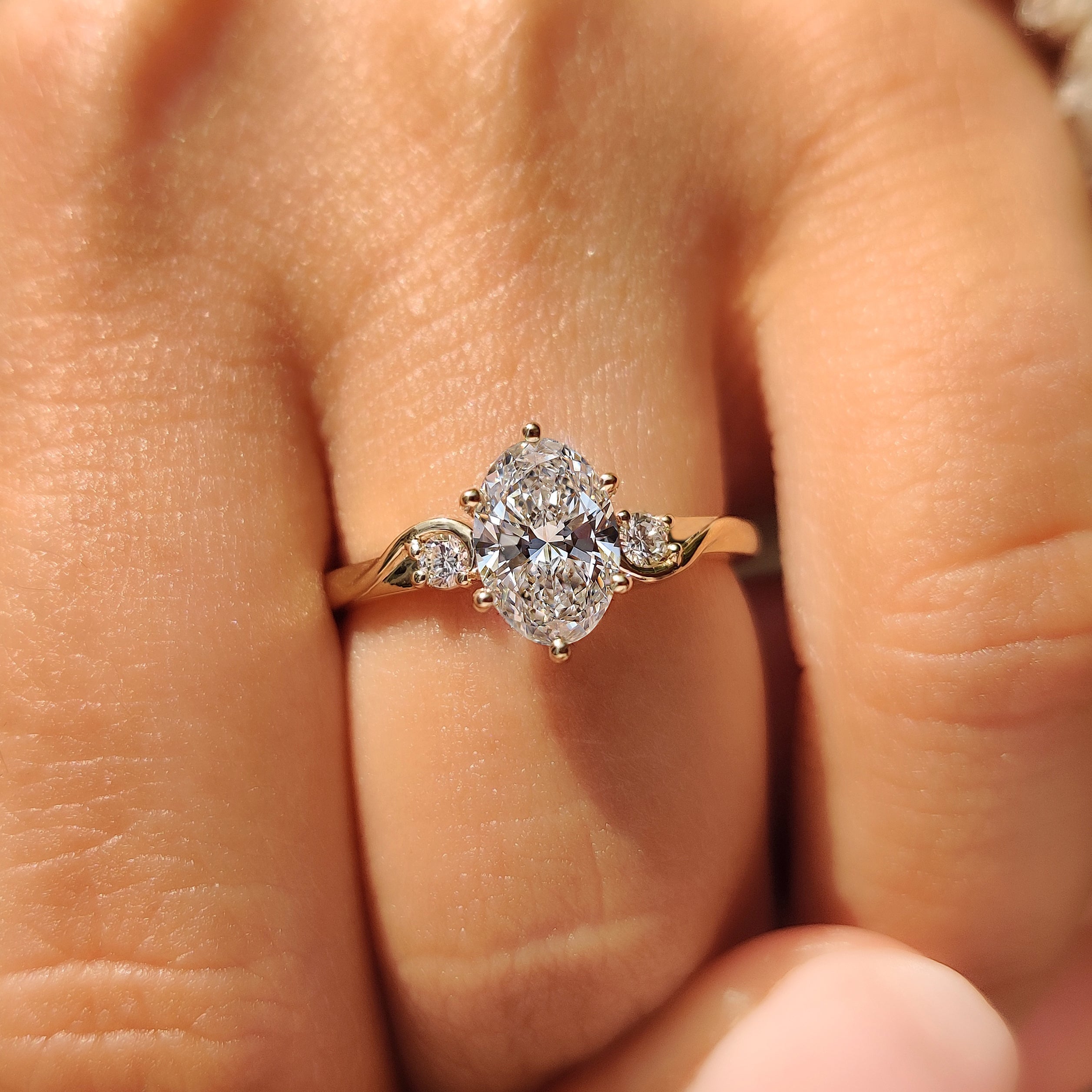 Handmade oval three stone ring with basket style setting

