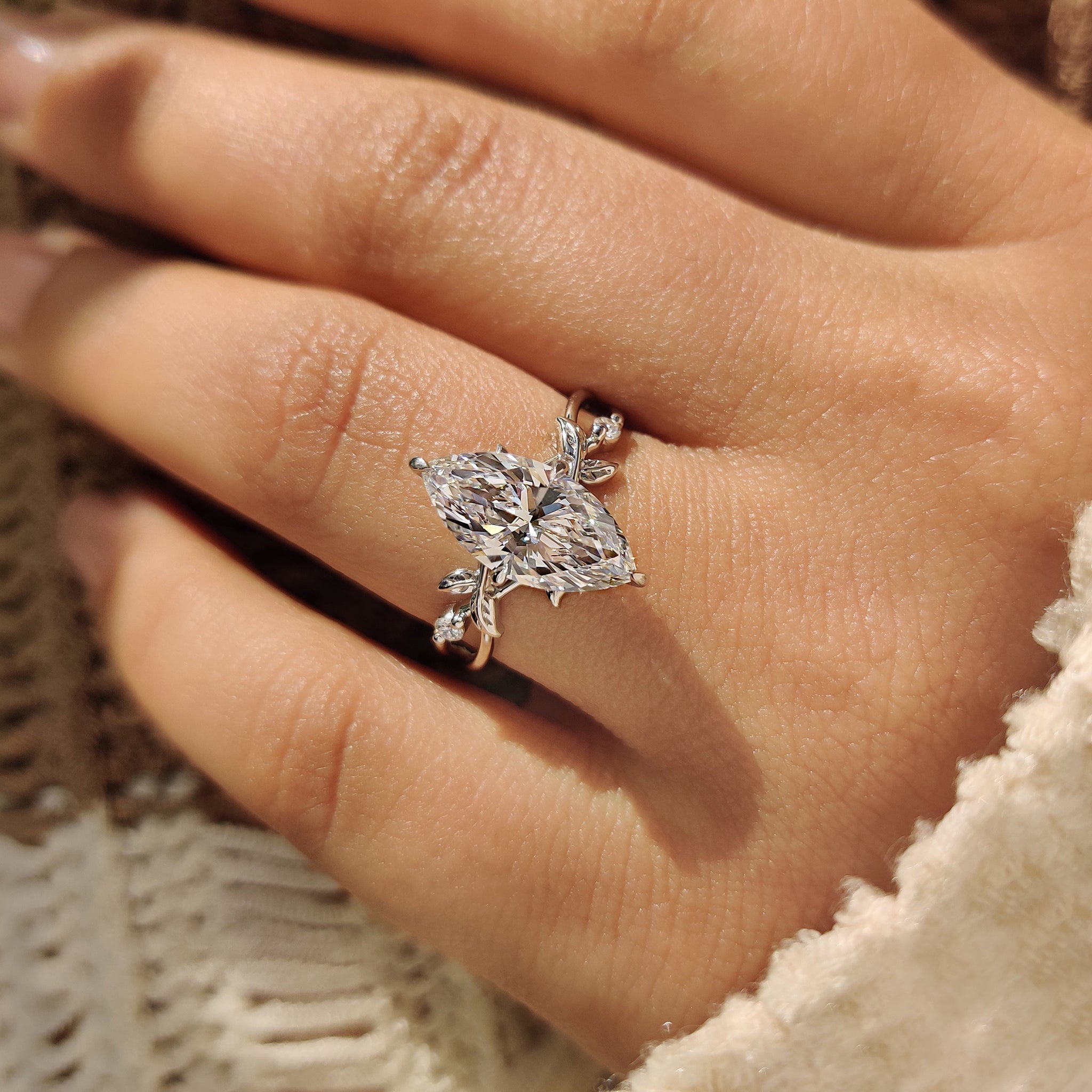 Handmade marquise cut ring with side stone details.

