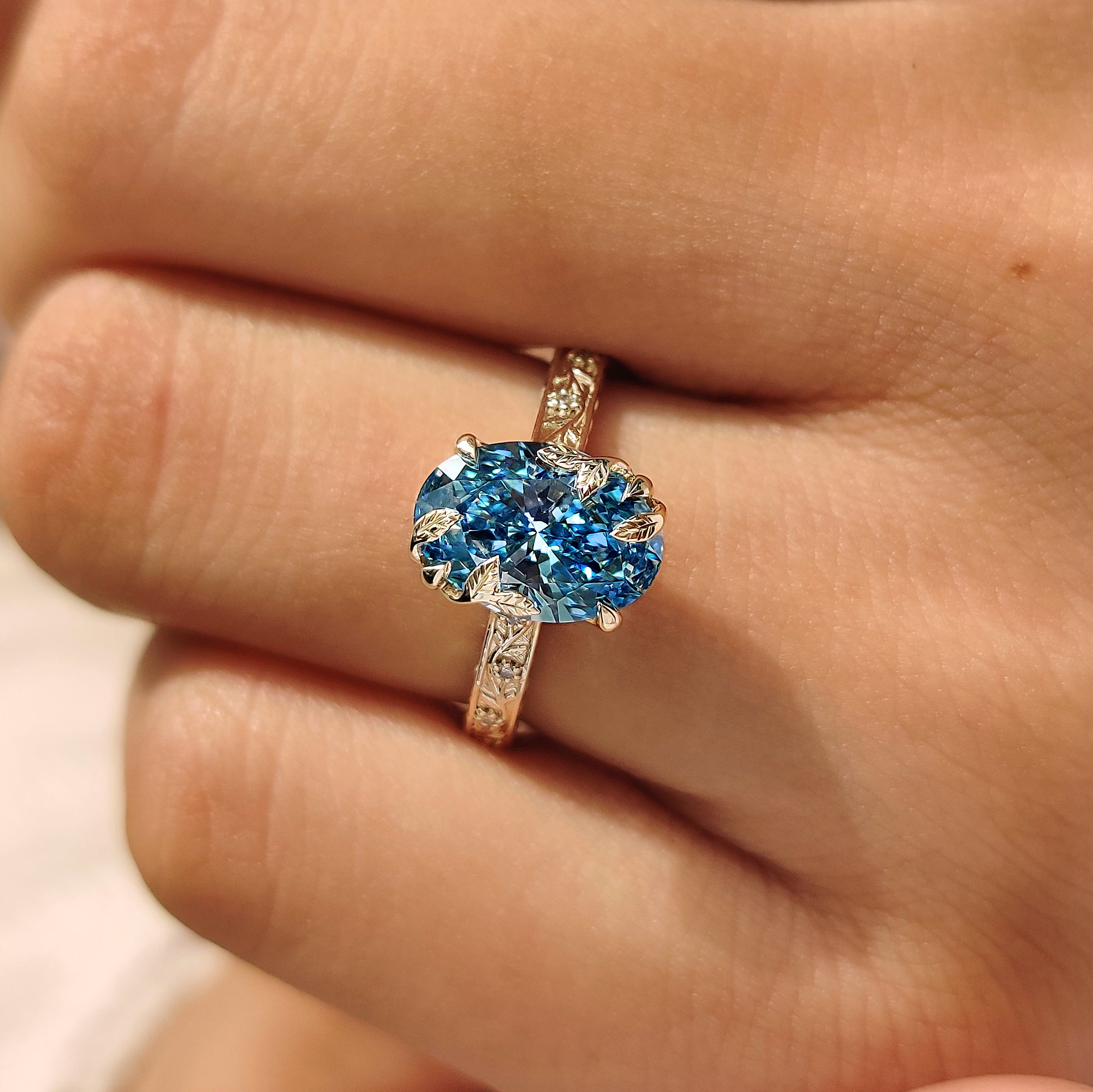 Engraved floral shank oval engagement ring
