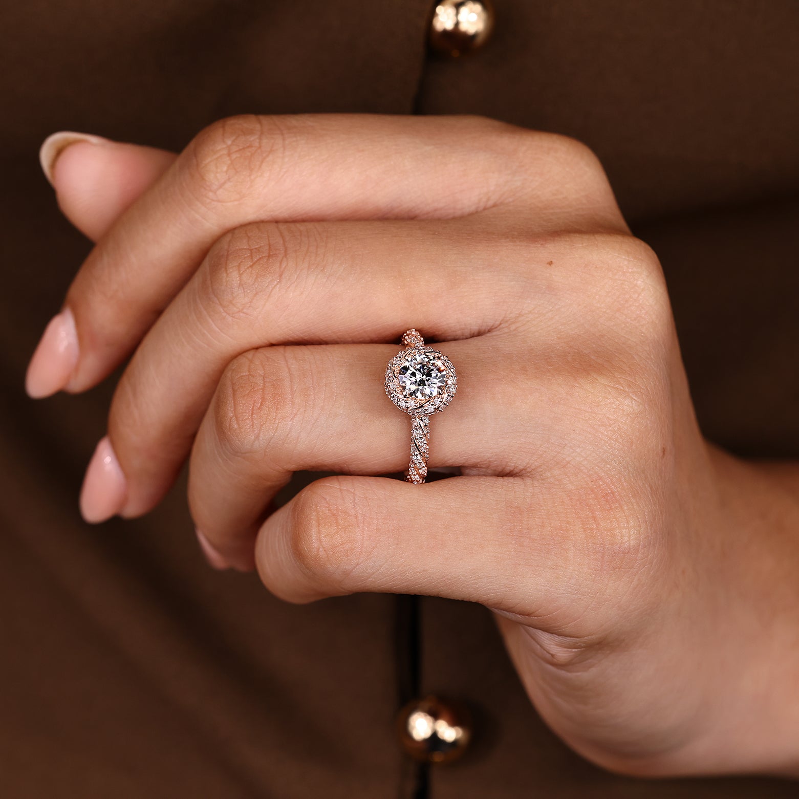 Twisted design round diamond ring with halo style setting
