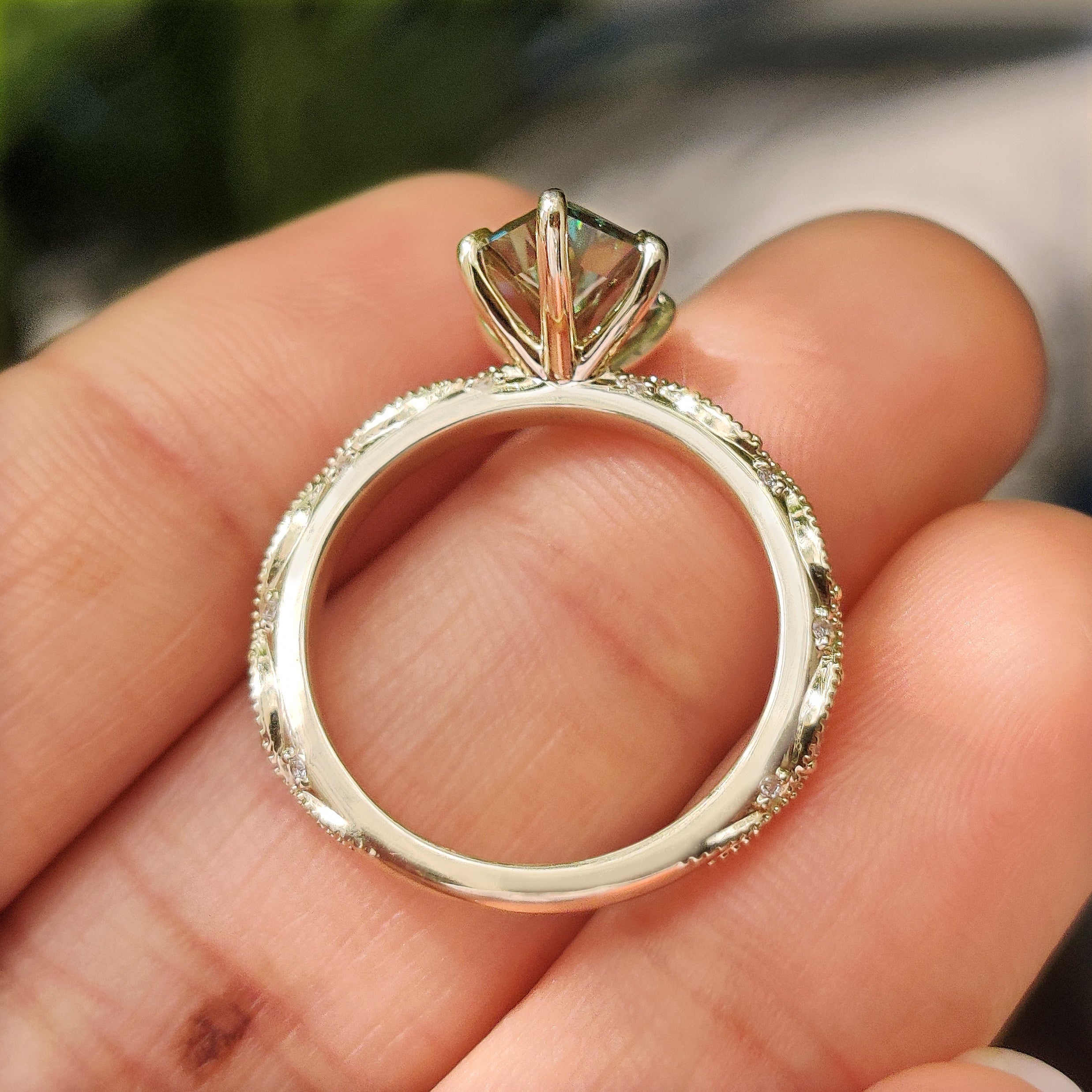 Green Dutch marquise ring with marquise and round side stones
