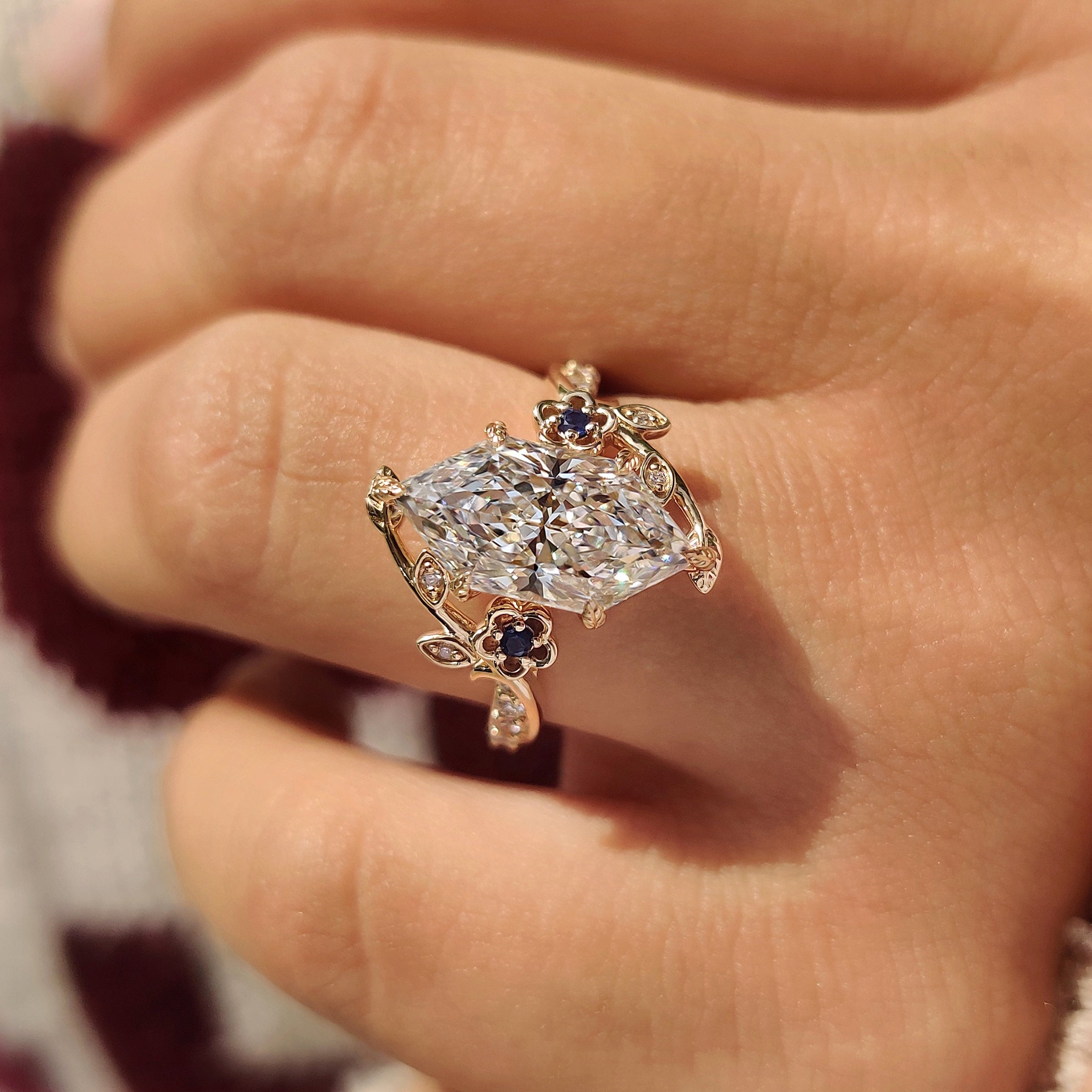 Center lab grown dutch marquise diamond with blue sapphire side stones
