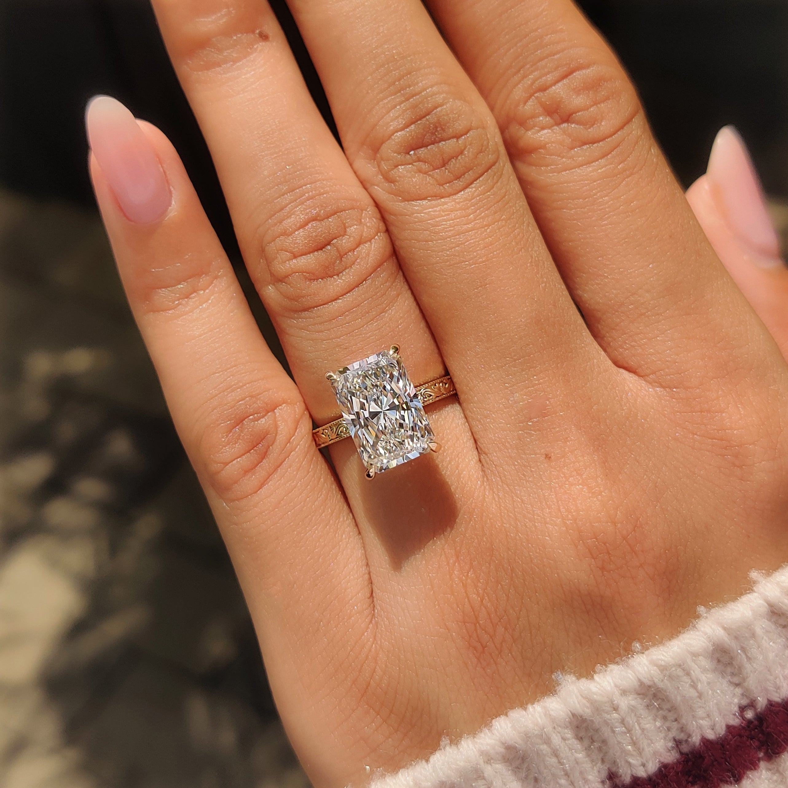 Handmade radiant engagement ring with filigree design.
