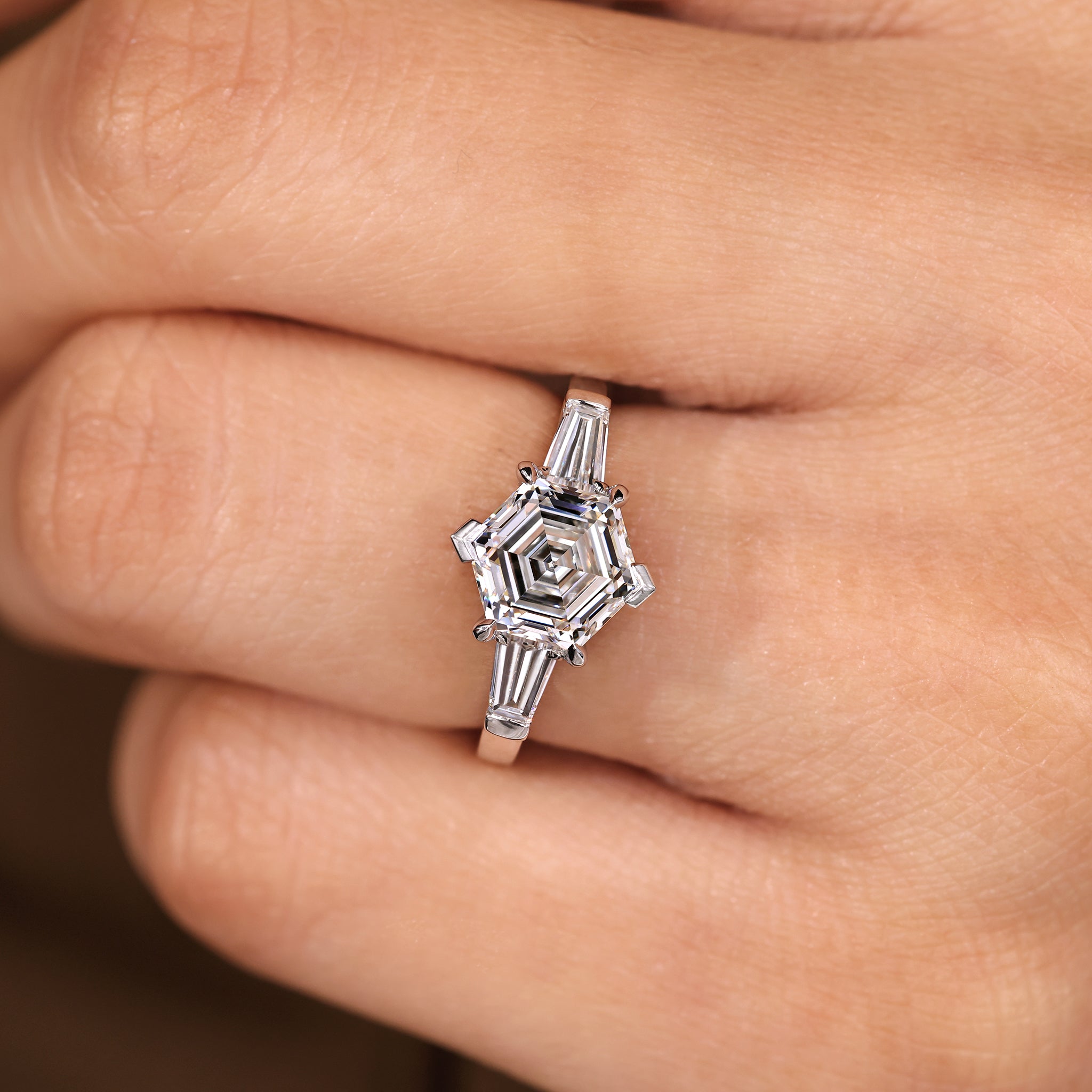 Three diamond ring with four prong and V prong setting.
