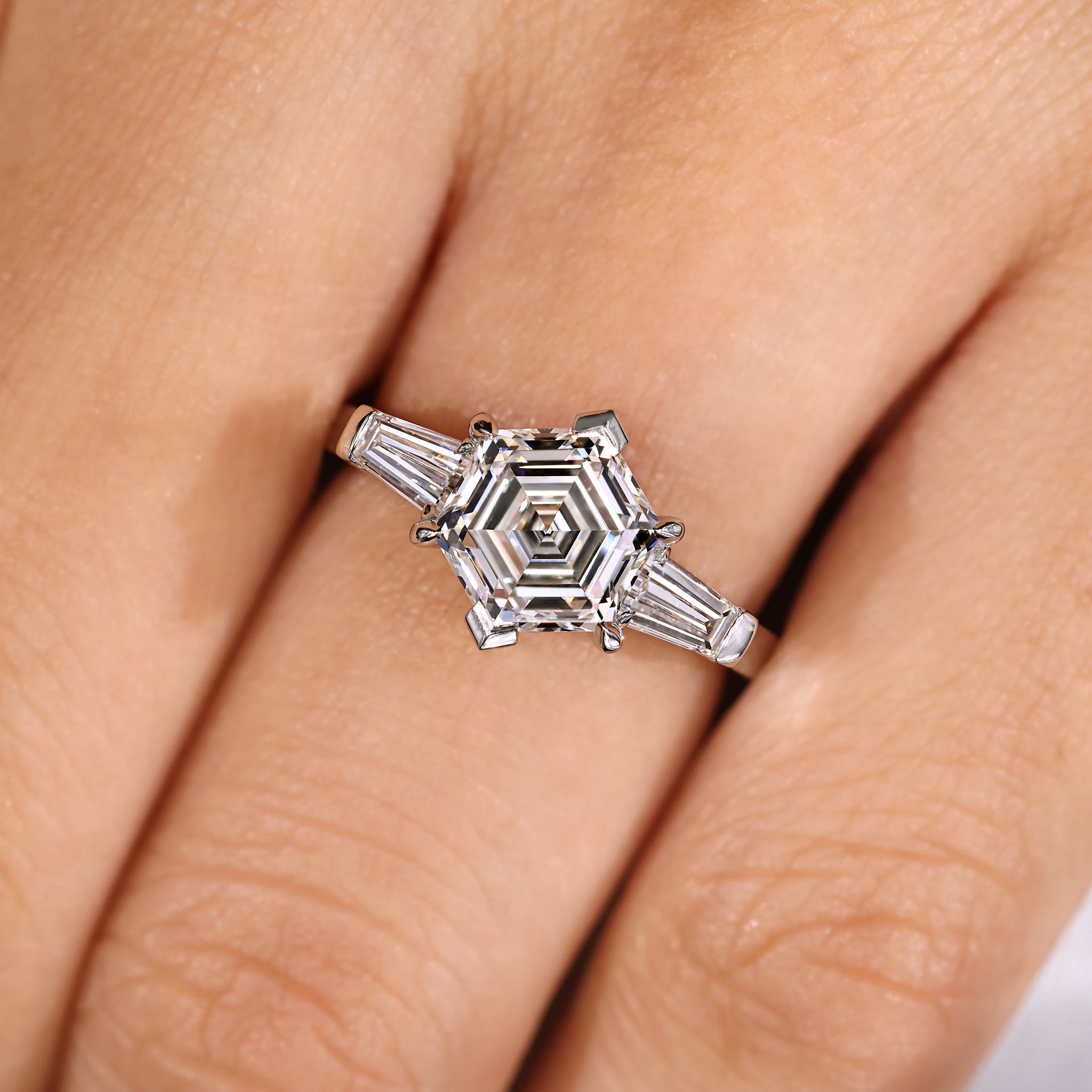 Lab grown three diamond ring with tapered baguette stones.
