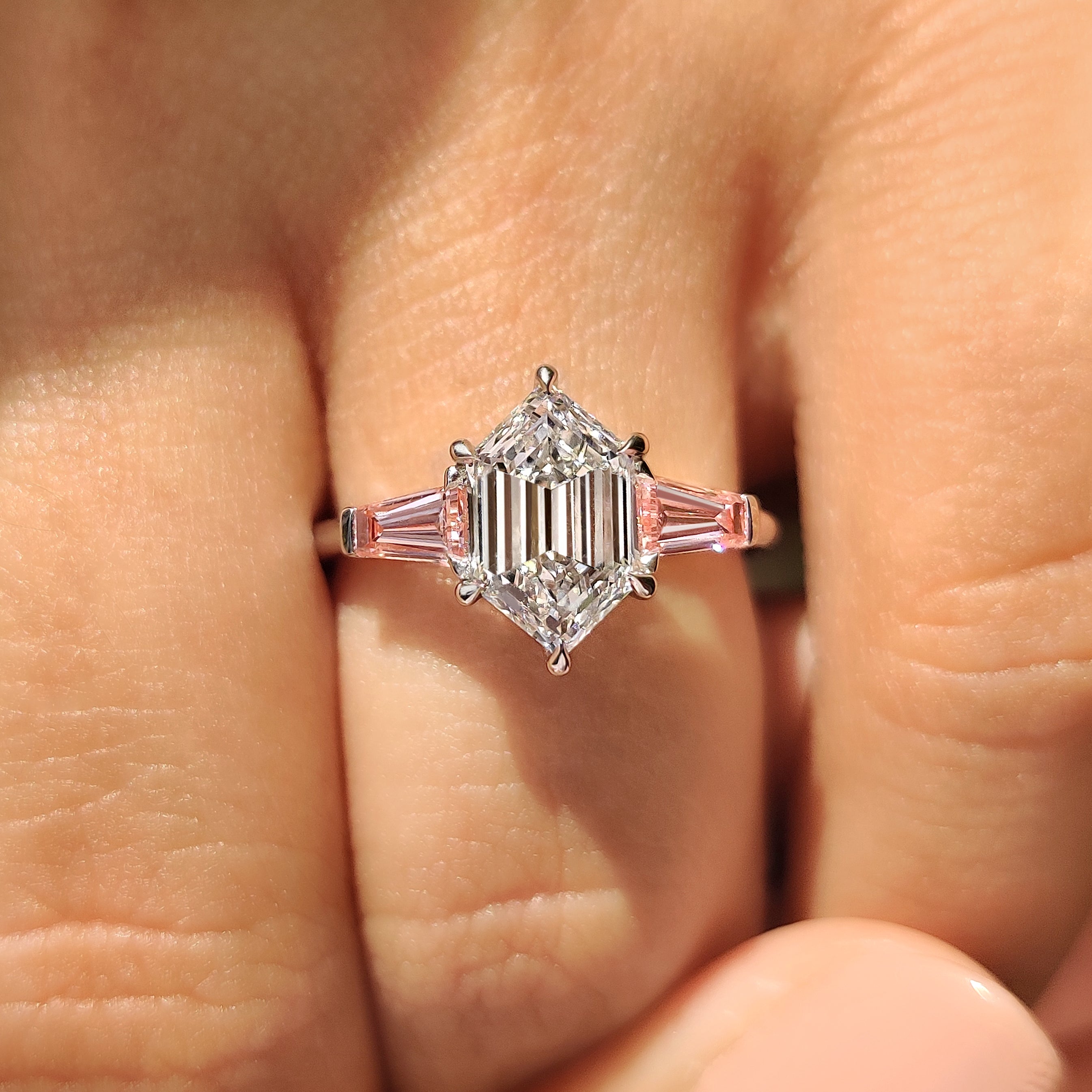 Hexagon center diamond ring with cathedral and claw prongs
