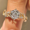 Hexagon cut engagement ring with marquise and round side stones
