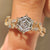 Hexagon cut engagement ring with marquise and round side stones

